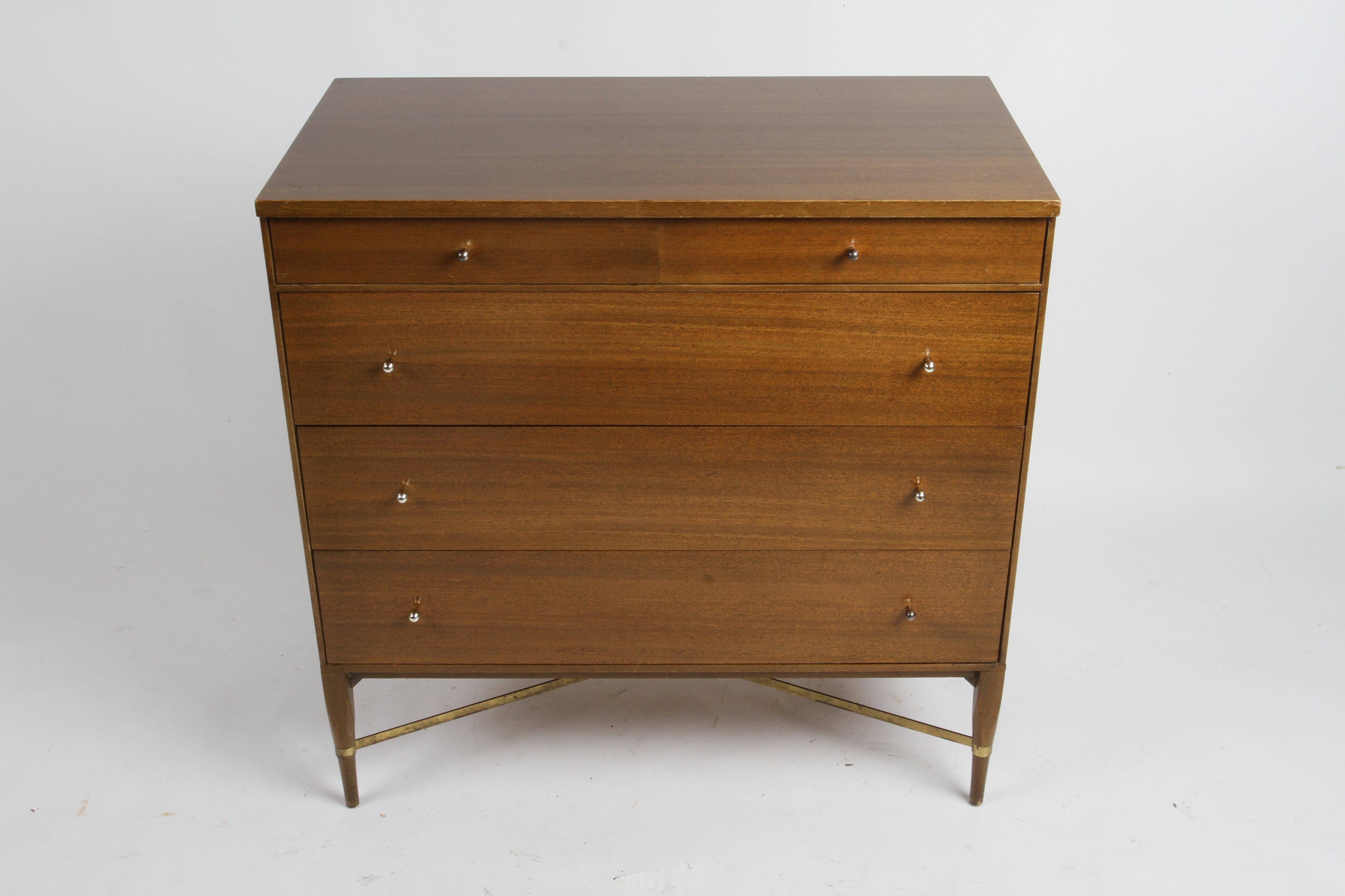A very nicely tailored medium dark mahogany Mid-Century chest designed by Paul McCobb for the Calvin Furniture Company. Having two smaller upper drawers and three larger lower drawers all with tear drop pulls. The bottom has a great X brushed brass