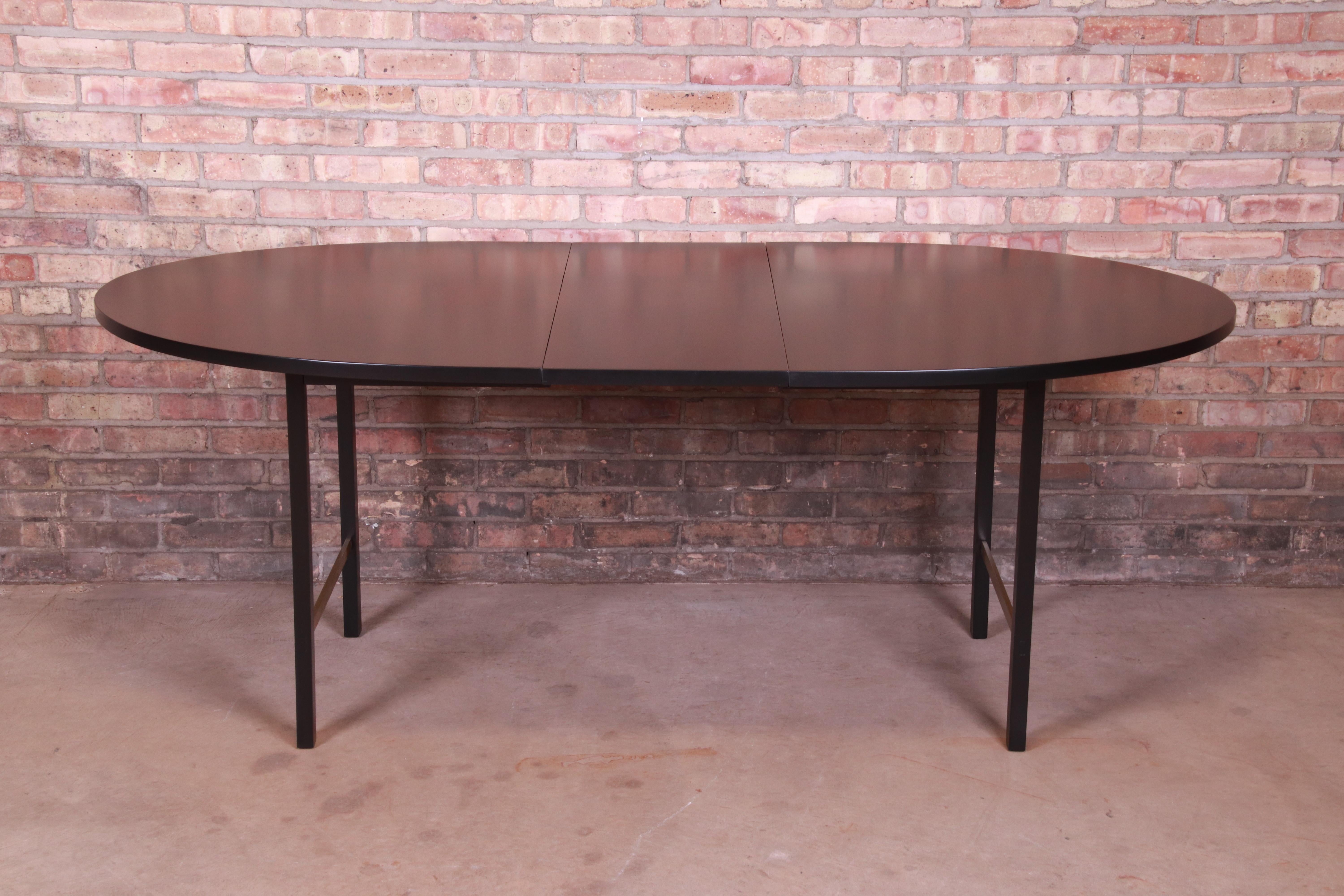 An exceptional Mid-Century Modern extension dining table

By Paul McCobb for Calvin Furniture

USA, 1950s

Black lacquered mahogany, with brass stretchers.

Measures: 61.75