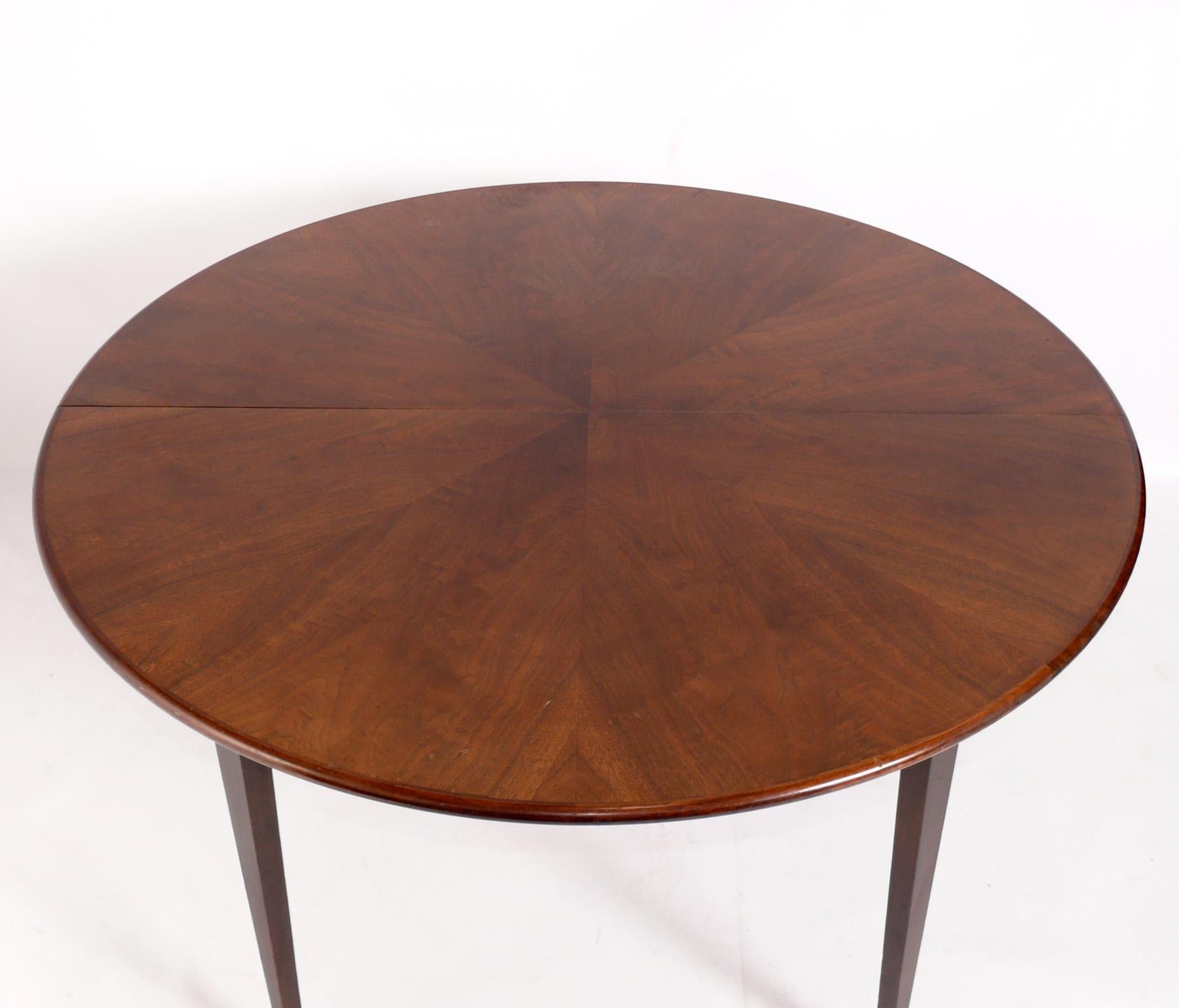 Élégante table de salle à manger du milieu du siècle, conçue par Paul McCobb pour la ligne Directional de Calvin Furniture, États-Unis, vers les années 1960. La table passe d'une table ronde de 48