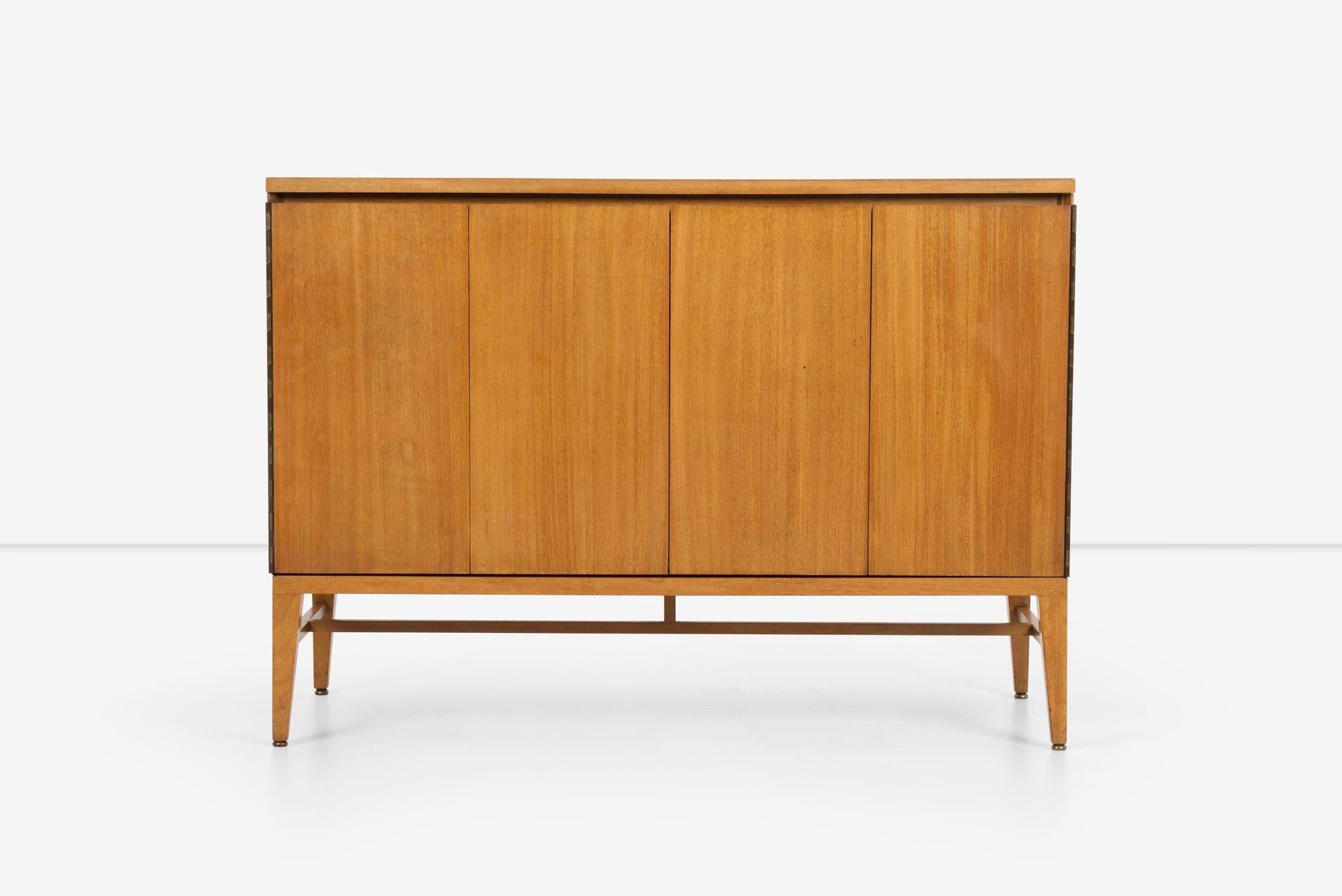 Paul McCobb Dresser for Calvin, features a rich Mahogany veneer. Its bi-fold doors, mounted on piano hinges, open up to reveal four spacious drawers. Additionally, the dresser offers convenient side compartment vertical storage alongside an