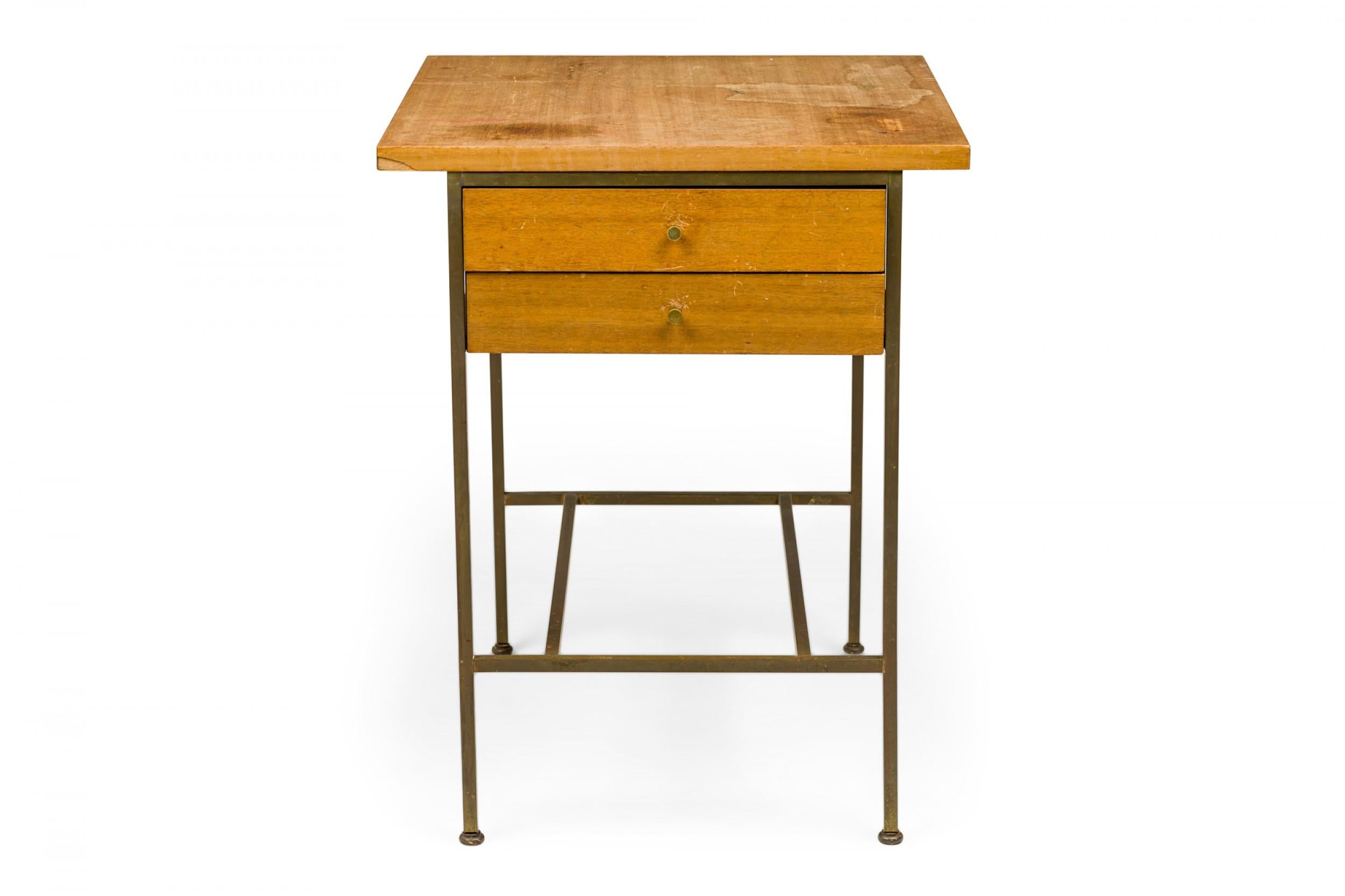 American mid-century rectangular nightstand / end table with a rectangular blond wooden top over two drawers with brass knob drawer pulls, supported by a brass frame with a stretcher base. (PAUL MCCOBB FOR CALVIN FURNITURE COMPANY)