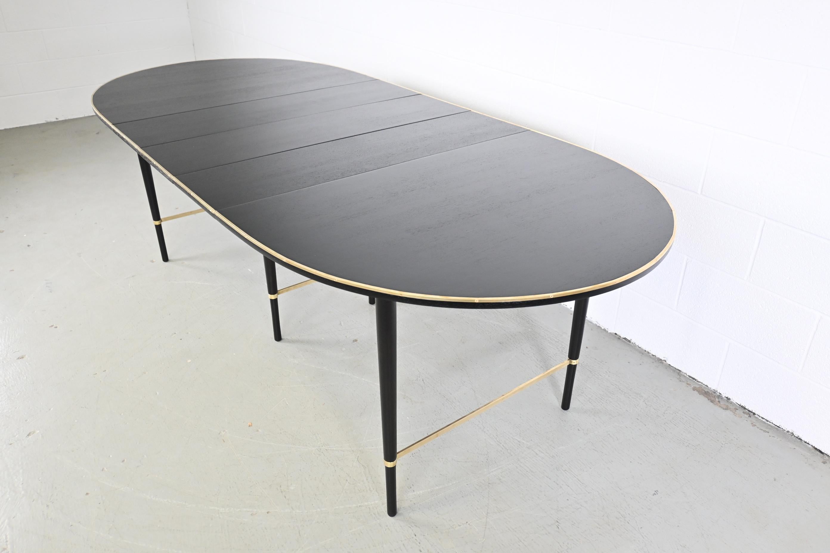 Paul McCobb for Calvin furniture ebonized mahogany and brass extension dining table

Calvin Furniture, USA, 1950s

61.13 Wide x 41.25 Deep x 29.25 High. Extends up to 94.13