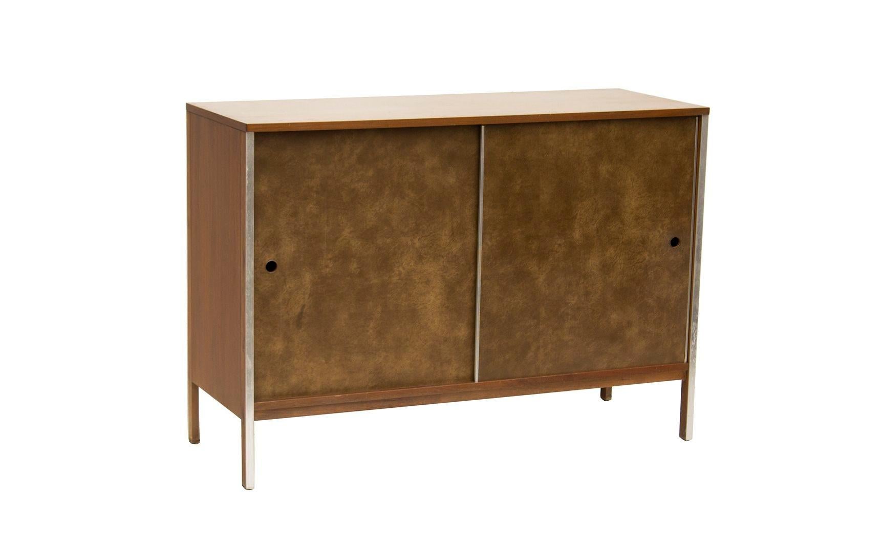 USA, 1960s
Mid-century buffet or sideboard designed by Paul McCobb for Calvin Furniture. Walnut, aluminum, and leatherette. The clean modern lines from the Linear Group line make this vintage credenza a handsome storage cabinet well suited to any