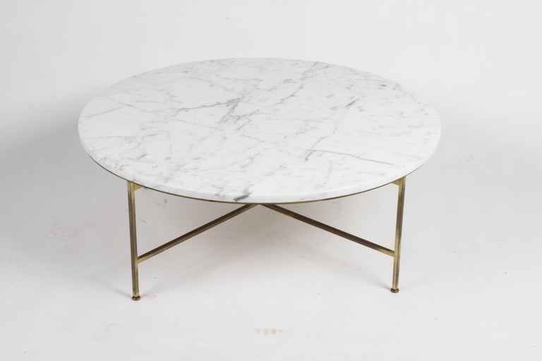 One owner circa 1955 Paul McCobb for Calvin Furniture round coffee table with beautiful Calacatta marble top with original patina to brass base and feet. Top is free of cracks and chips.