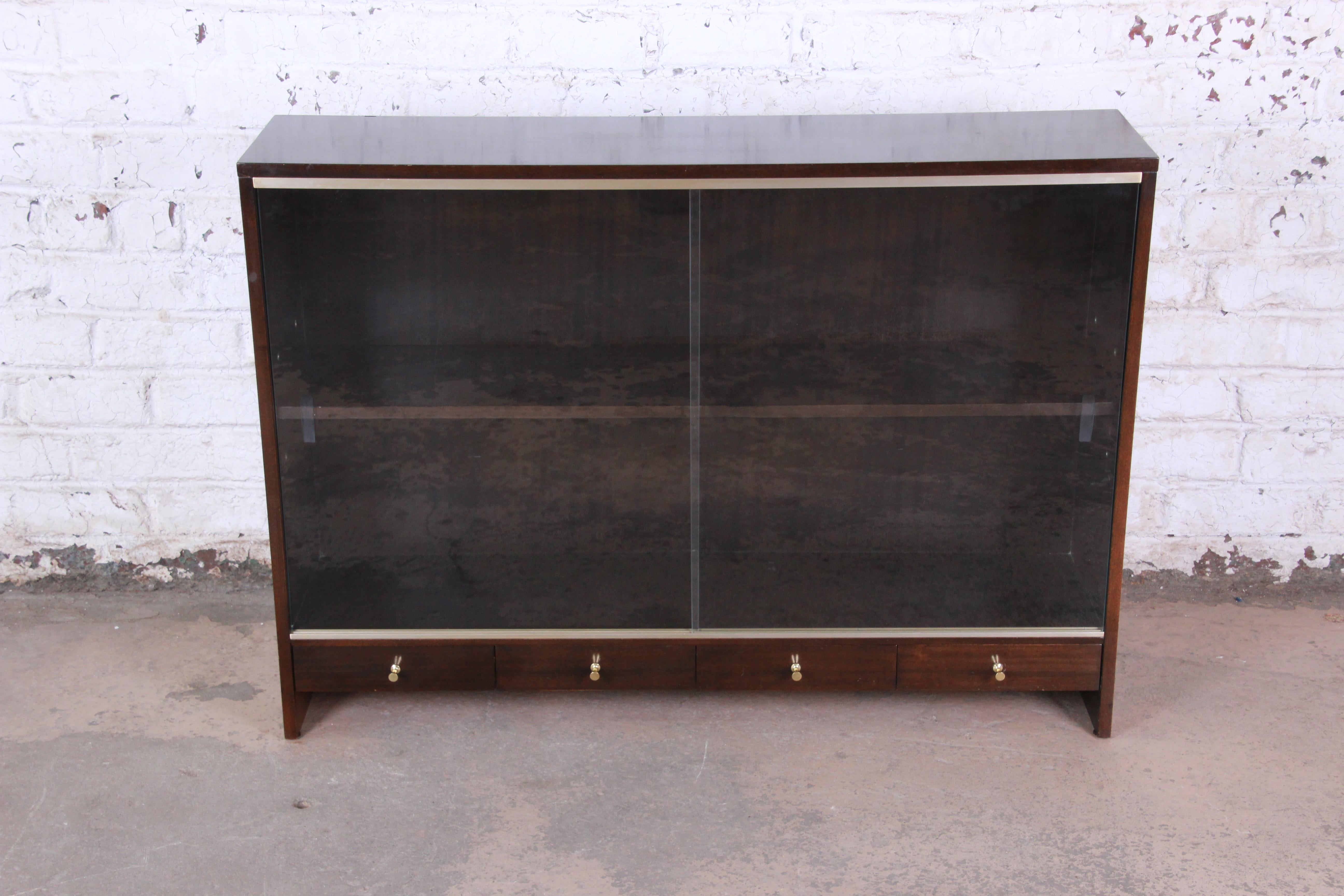 A sleek and stylish glass front bookcase or display cabinet designed by Paul McCobb for his 