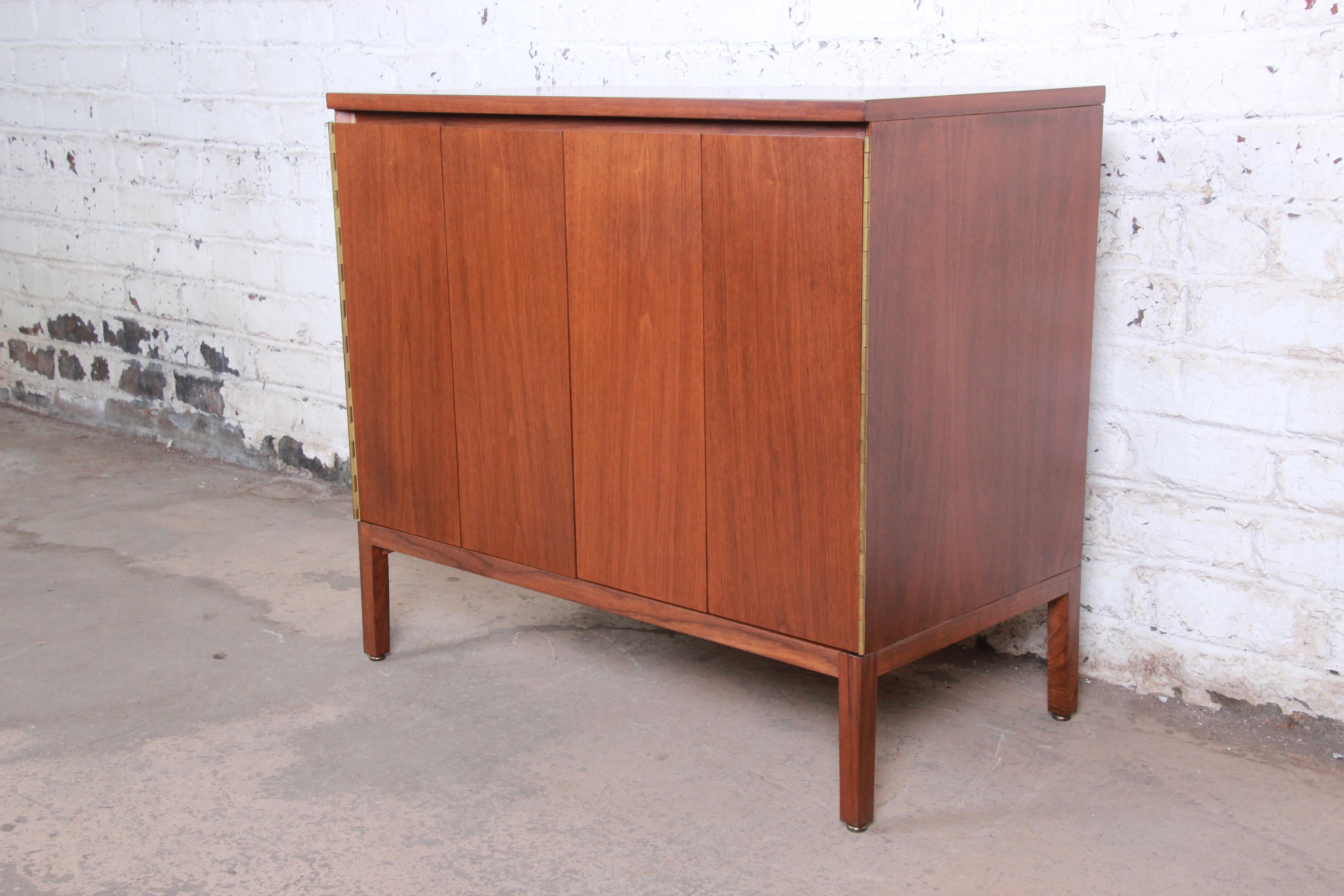 An exceptional Mid-Century Modern sideboard credenza or bar cabinet designed by Paul McCobb for his Irwin Collection line for Calvin Furniture. The cabinet features stunning Honduran mahogany wood grain and sleek midcentury lines. An excellent
