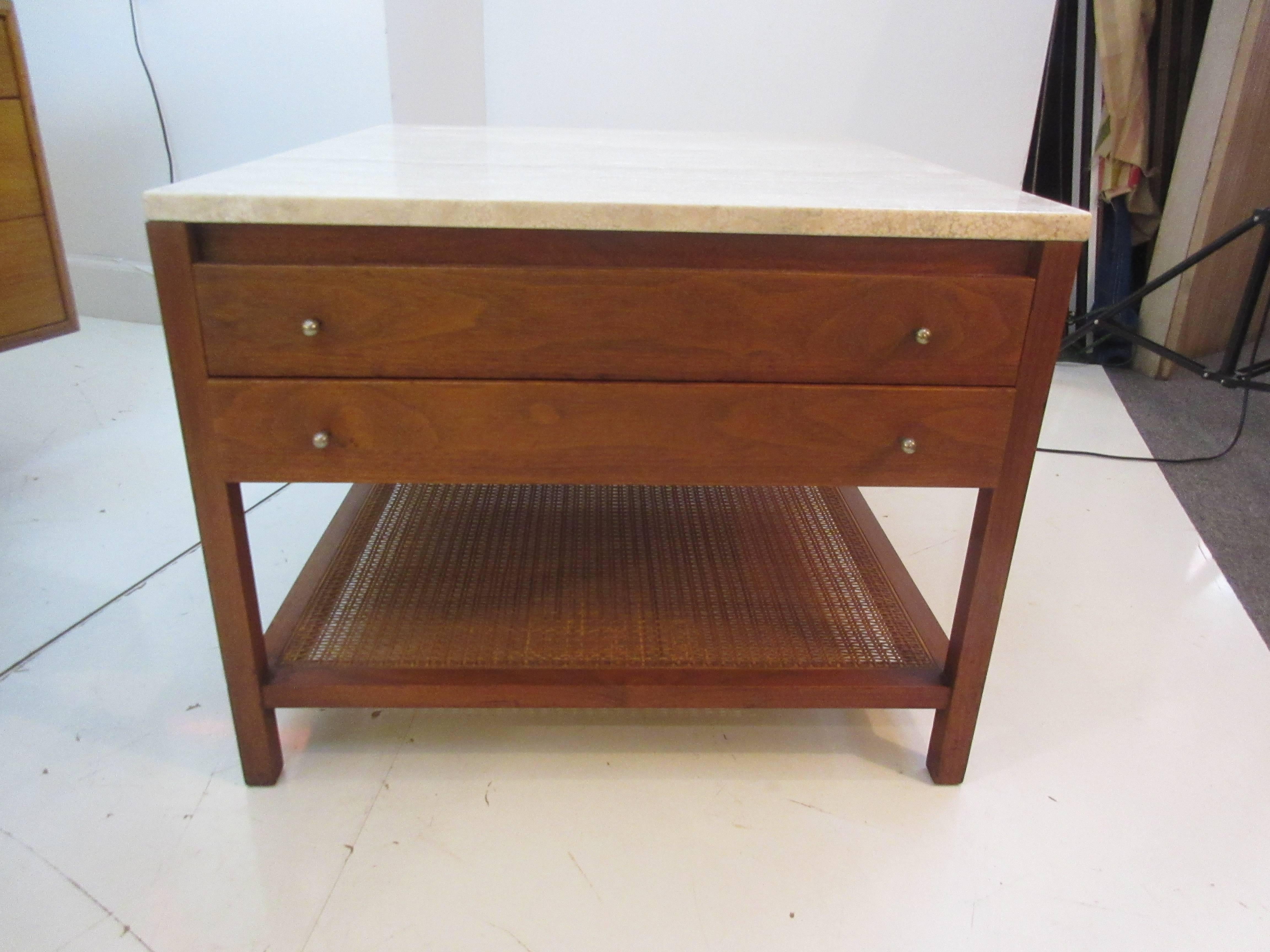 Paul McCobb for Calvin lamp table with rattan shelf, crema marble top and walnut frame. Two pull out drawers with nickel pulls. Metal tag is intact.