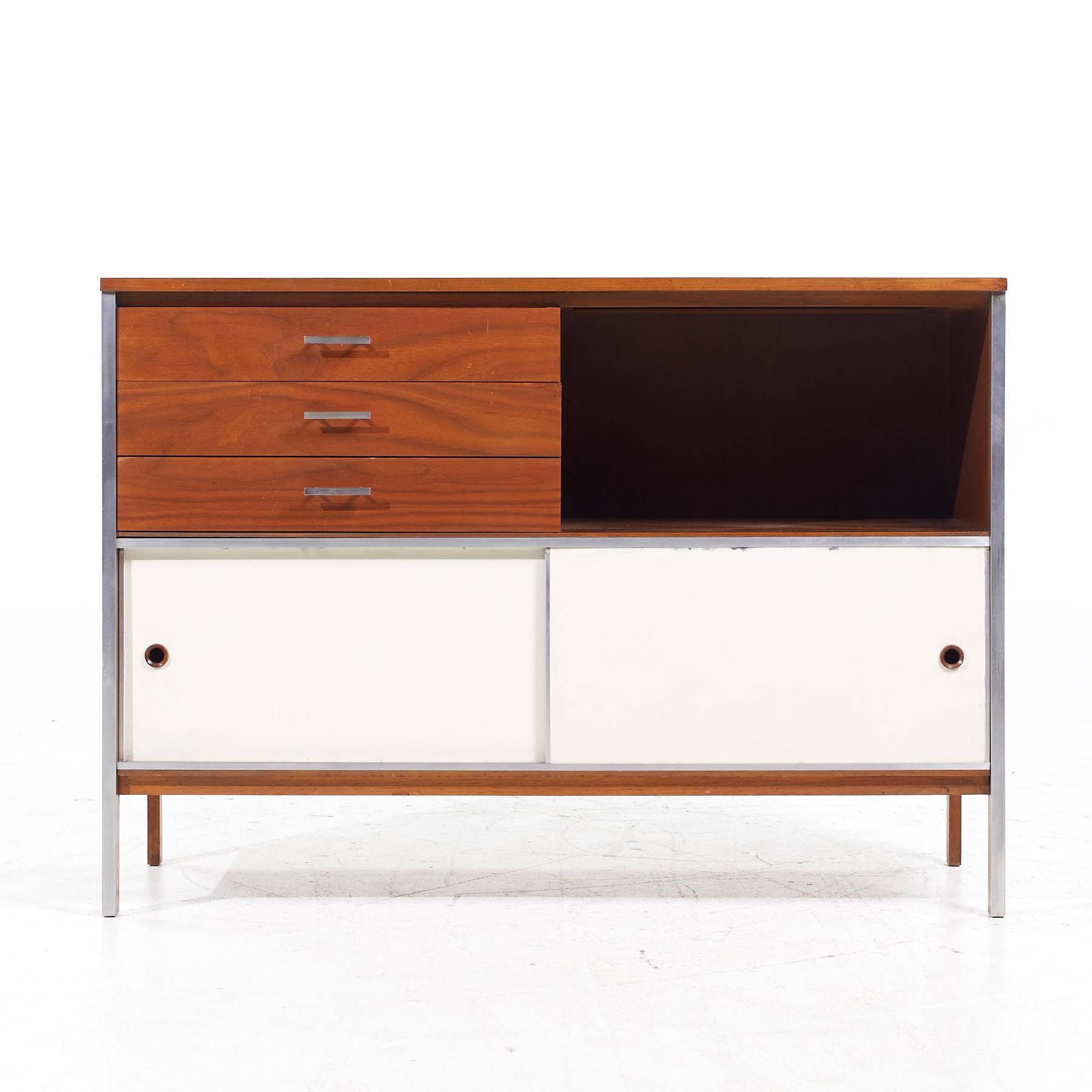 Paul McCobb for Calvin Mid Century Walnut and Stainless Steel Sliding Door Credenza

This credenza measures: 48 wide x 18 deep x 34 inches high

All pieces of furniture can be had in what we call restored vintage condition. That means the piece is