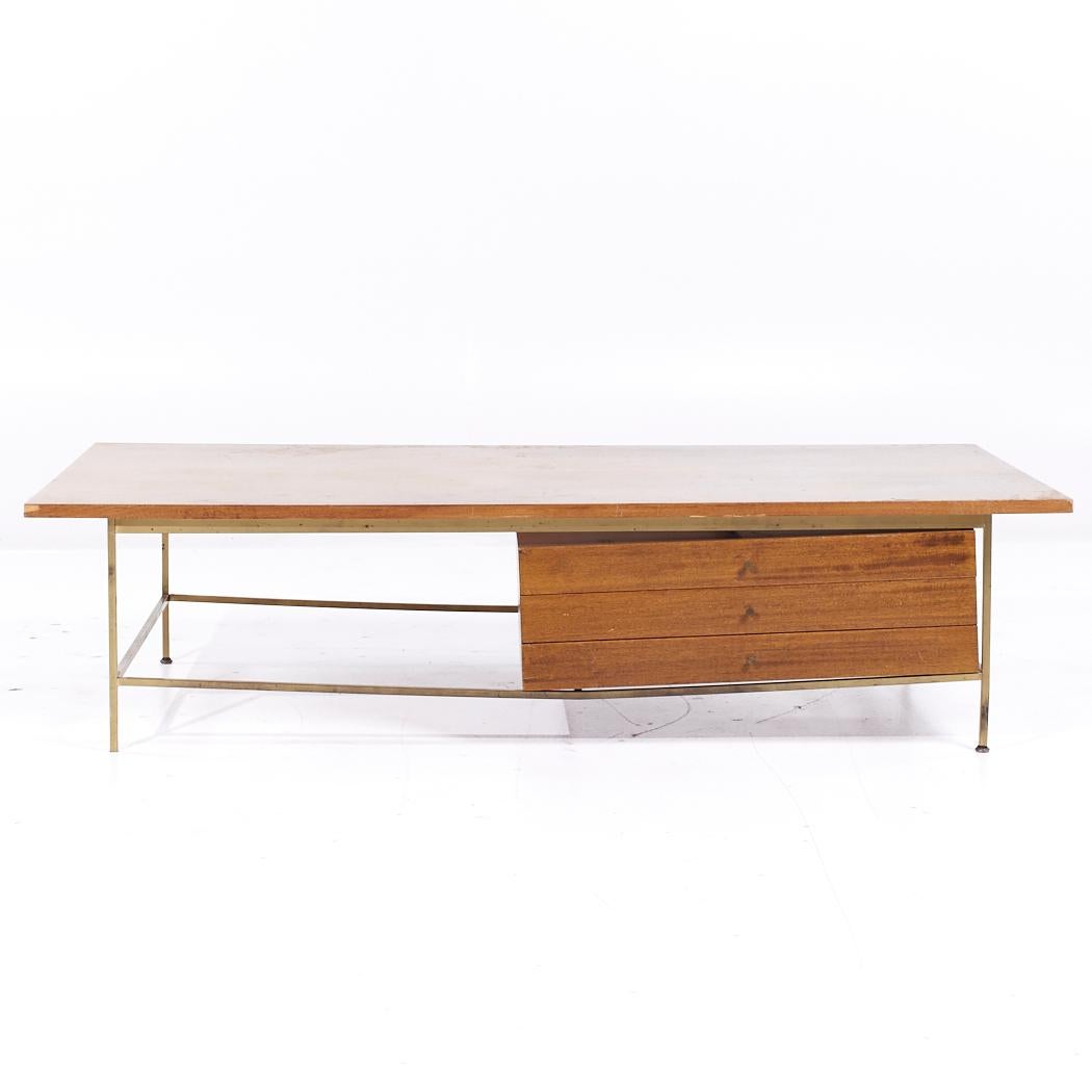 Paul McCobb for Calvin Mid Century Bleached Mahogany and Brass Coffee Table

This coffee table measures: 66 wide x 32 deep x 16 inches high

All pieces of furniture can be had in what we call restored vintage condition. That means the piece is
