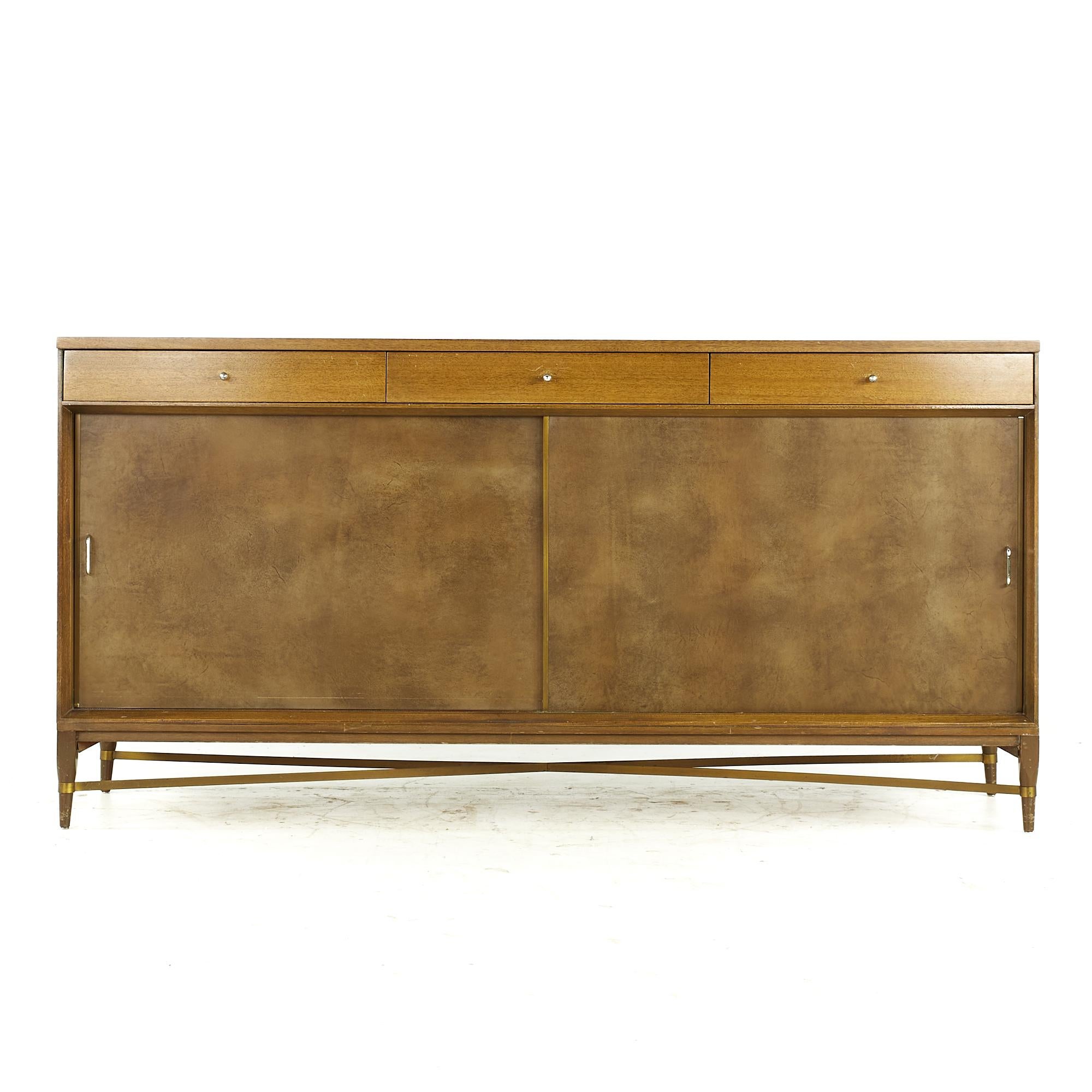 Paul McCobb for Calvin midcentury Mahogany and Brass Credenza

This credenza measures: 66 wide x 19.25 deep x 33.25 inches high

All pieces of furniture can be had in what we call restored vintage condition. That means the piece is restored upon