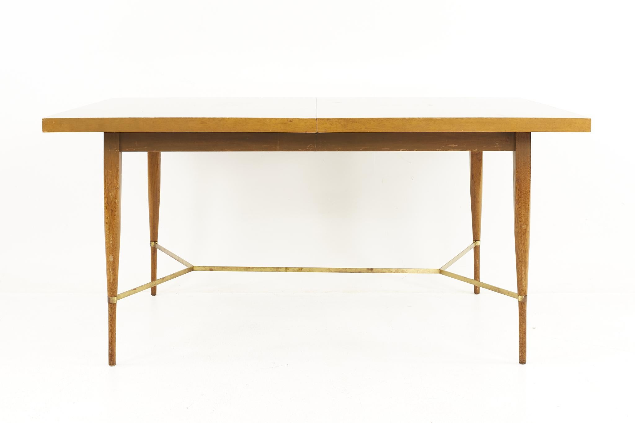 Paul McCobb for Calvin Mid Century Mahogany and Brass Expanding Dining Table

The table measures: 60 wide x 38 deep x 28.75 high, with a chair clearance of 24.5 inches; each leaf is 12 inches wide, making a maximum table width of 84 inches when