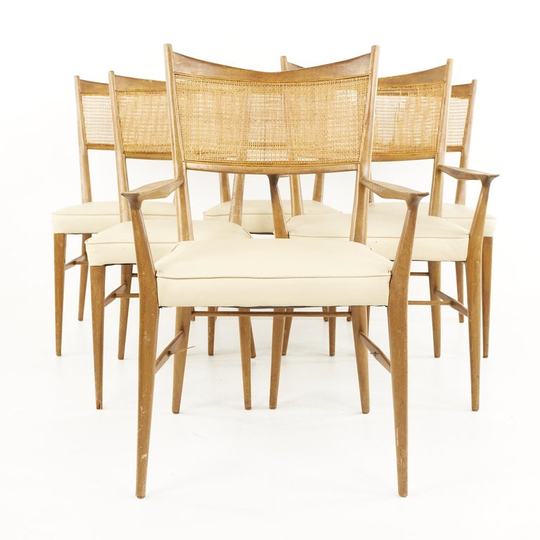 Paul McCobb For Calvin mid century walnut and cane dining chairs - Set of 6

Each chair measures: 16.75 wide x 20.5 deep x 34.5 high, with a seat height of 17.5 inches
The captains' chair measures: 22.75 wide x 23.5 deep x 36.75 high, with a seat