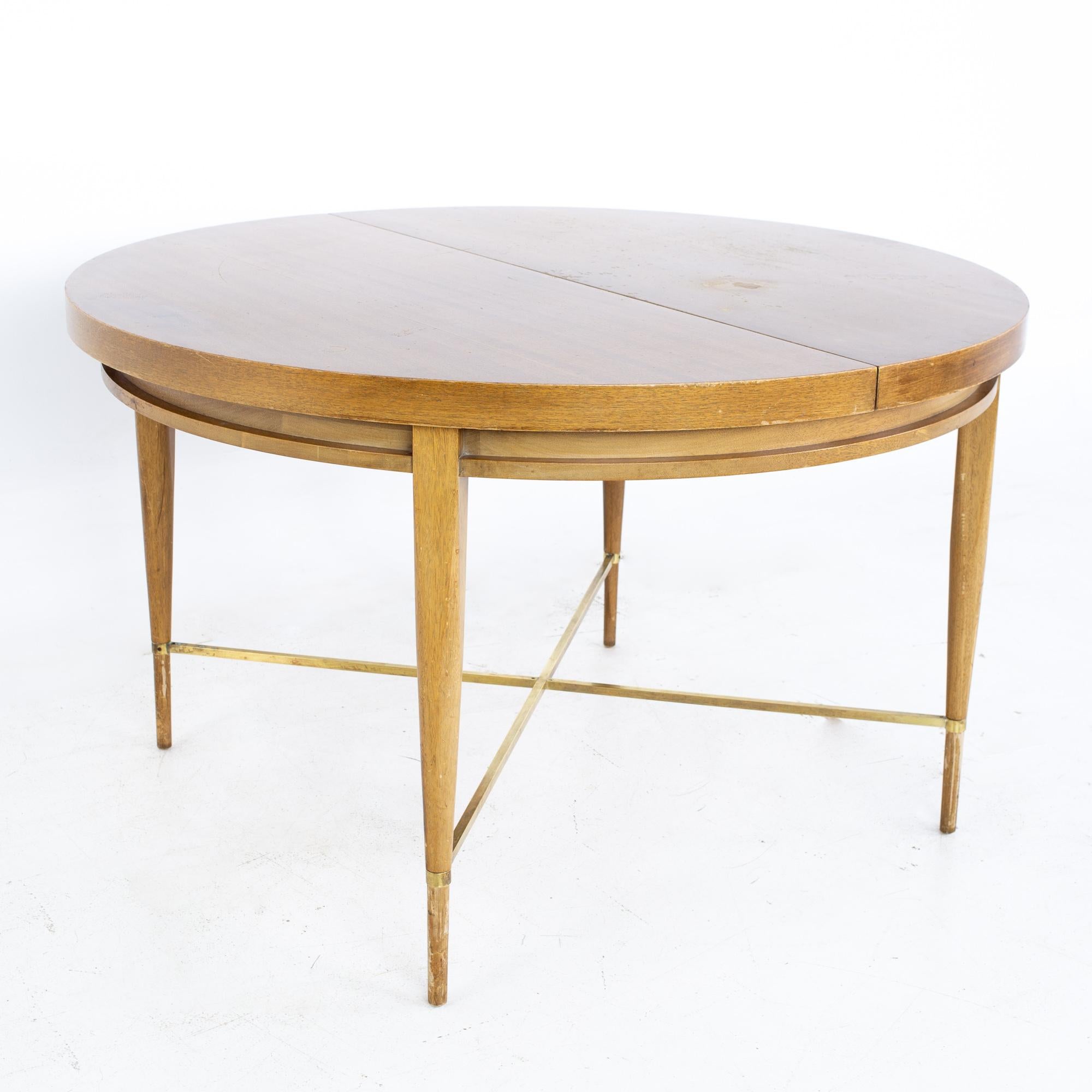 Paul McCobb for Calvin mid century mahogany and brass expanding round oval dining table
Table measures: 48 wide x 48 deep x 29 inches high; each leaf is 12 inches wide, making a maximum table width of 72 inches when both leaves are used. The chair