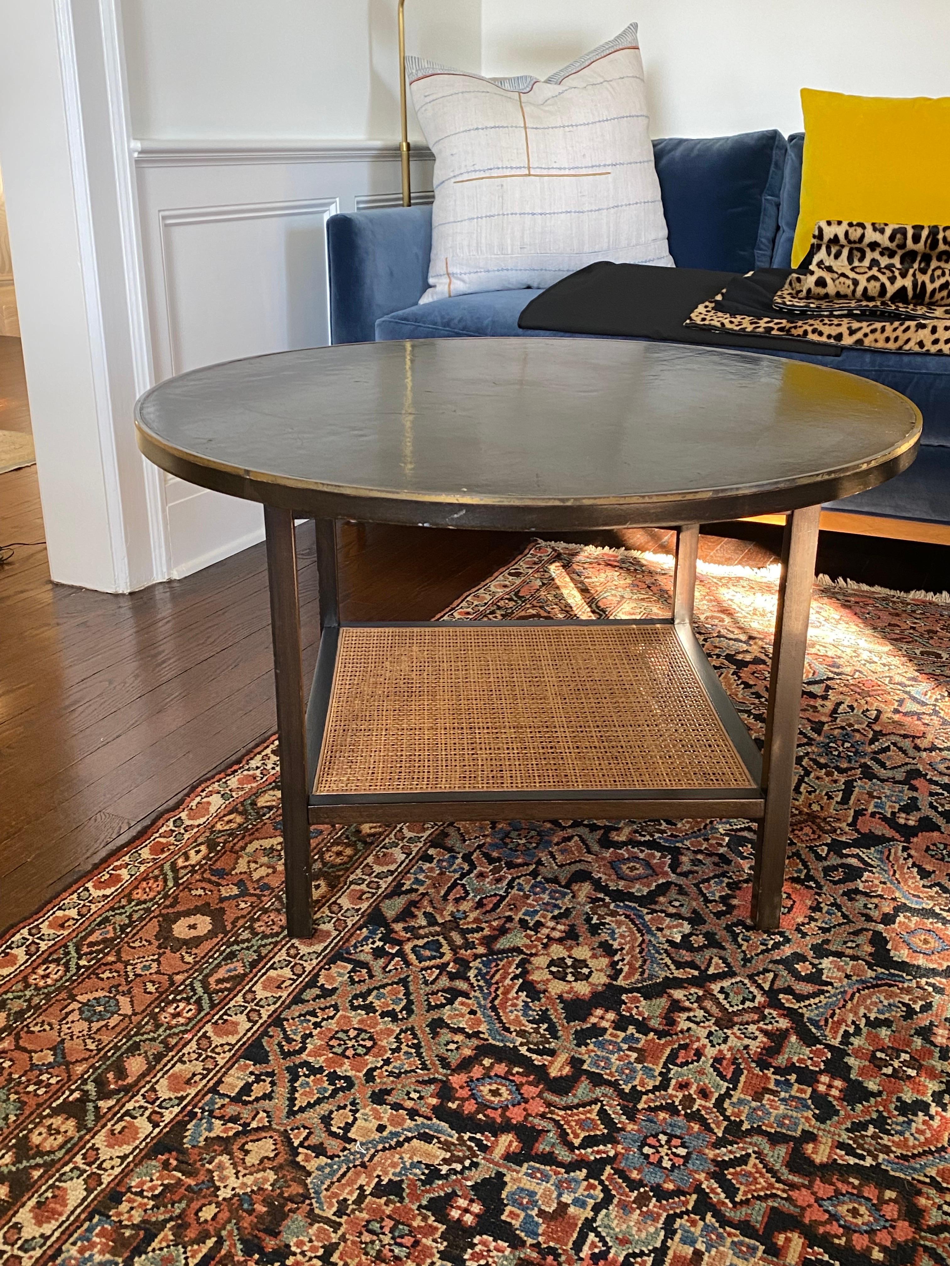 Paul McCobb for Calvin Round Mahogany Table with Reed Shelf & Brass Edge Trim.
A great looking side table or round coffee table. Brass edging around round top. Mahogany top and frame with lower reed shelf. General wear, scuffs and scratches to
