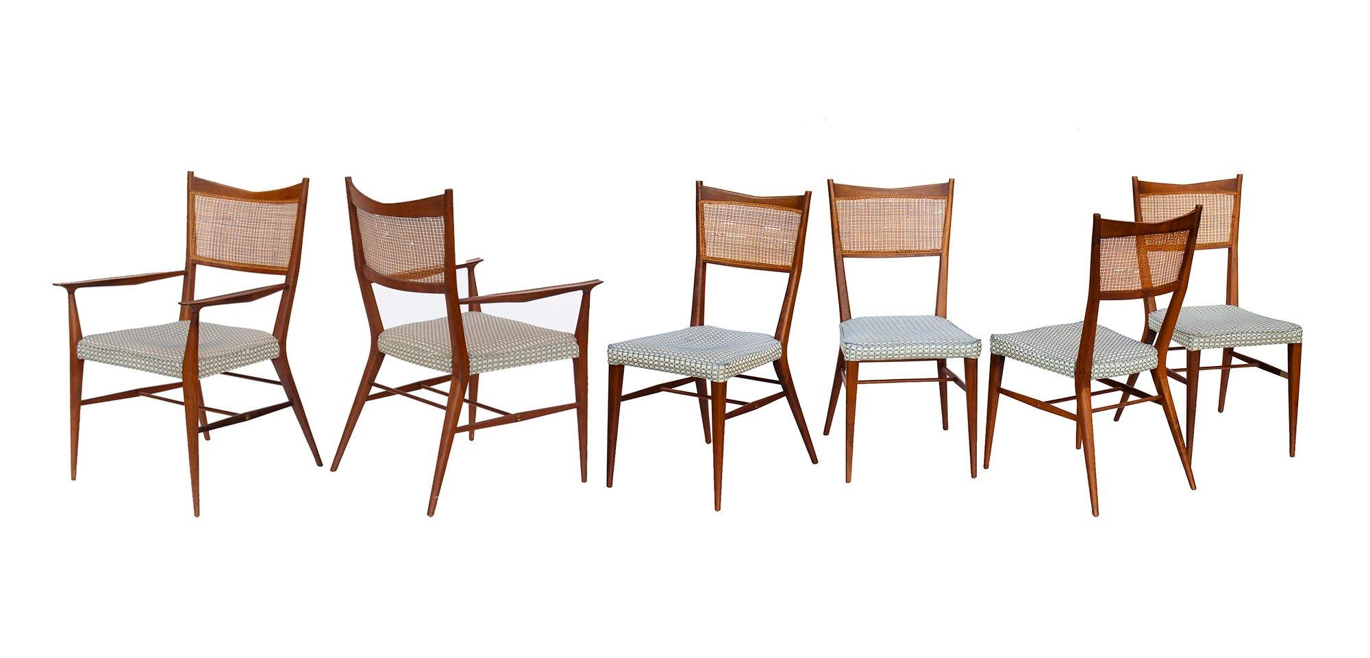 États-Unis, années 1950
Ensemble de chaises de salle à manger en noyer avec dossier canné, Paul McCobb for Calvin. L'ensemble comprend deux fauteuils et quatre chaises d'appoint, tous avec leurs sièges en tissu d'origine dans un tweed bleu