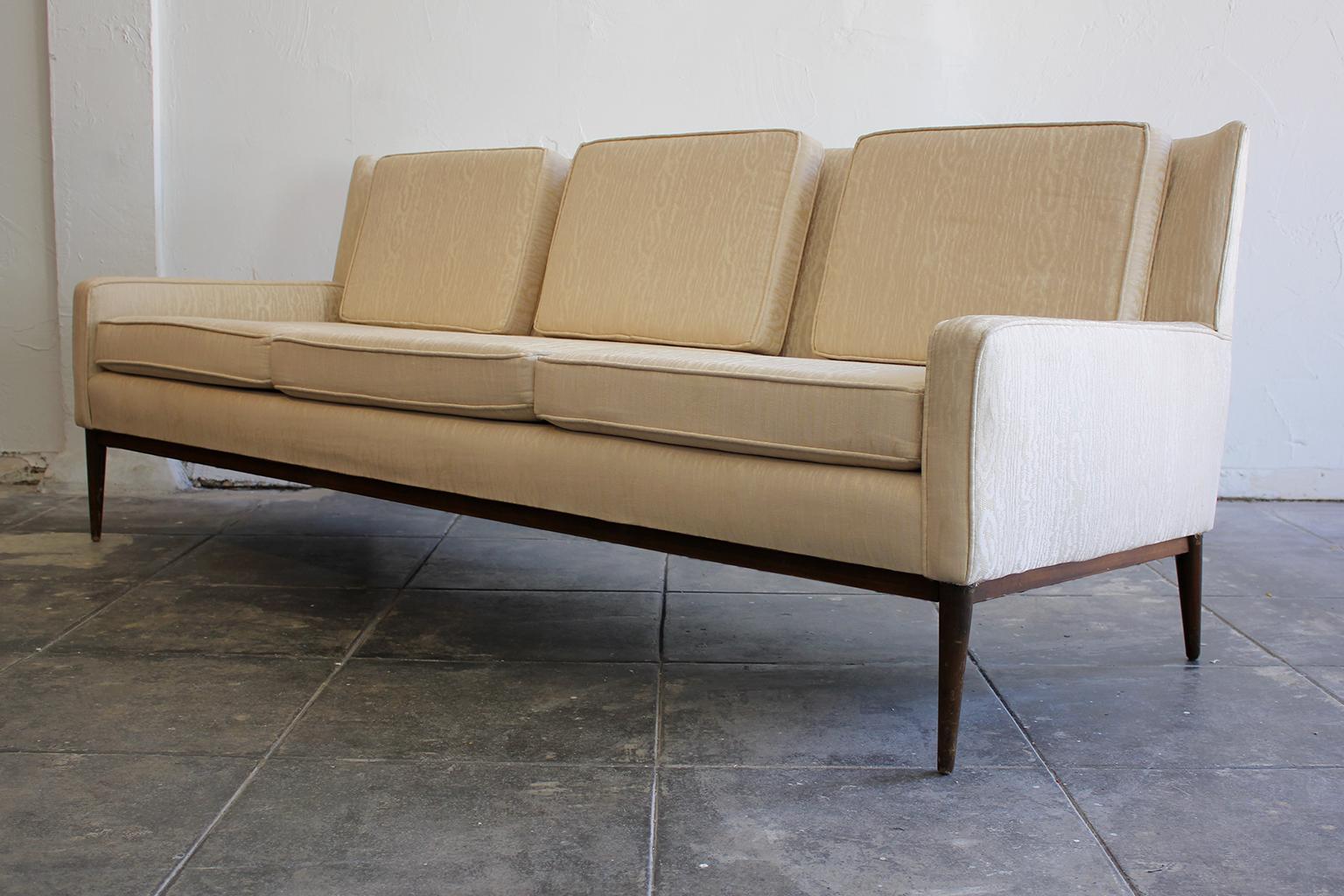 Elegant modern design 3-seat wingback sofa designed by Paul McCobb for Directional, circa 1950s. This has been intentionally left in as-found condition. Upholstery is in good condition and can be used as-is. Minor wear from use as pictured. Light