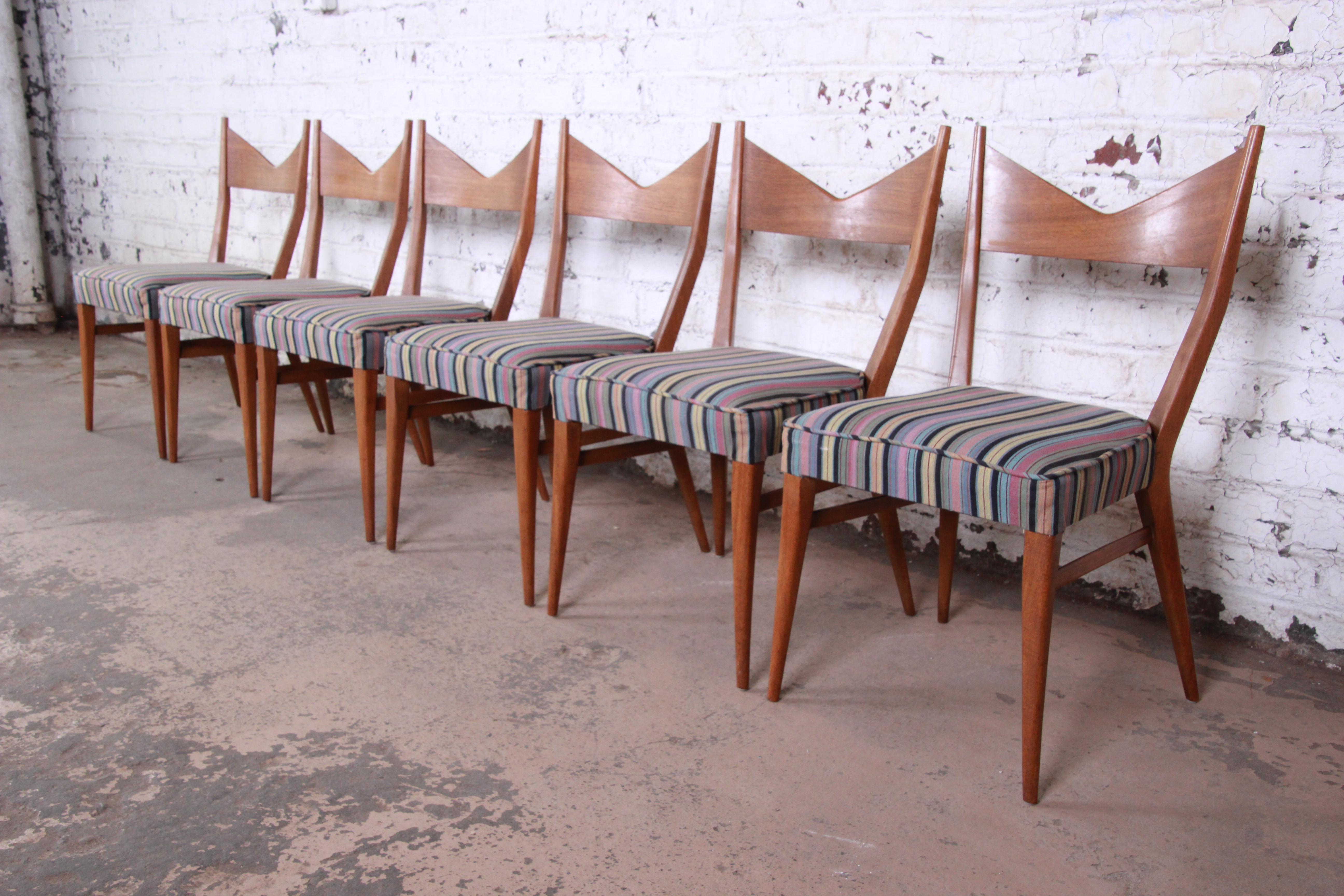 An exceptional set of six sculpted mahogany model 1080 bow tie dining chairs designed by Paul McCobb for Directional and produced by Calvin Furniture of Grand Rapids. The chairs feature stunning sculpted mahogany frames--an excellent example of