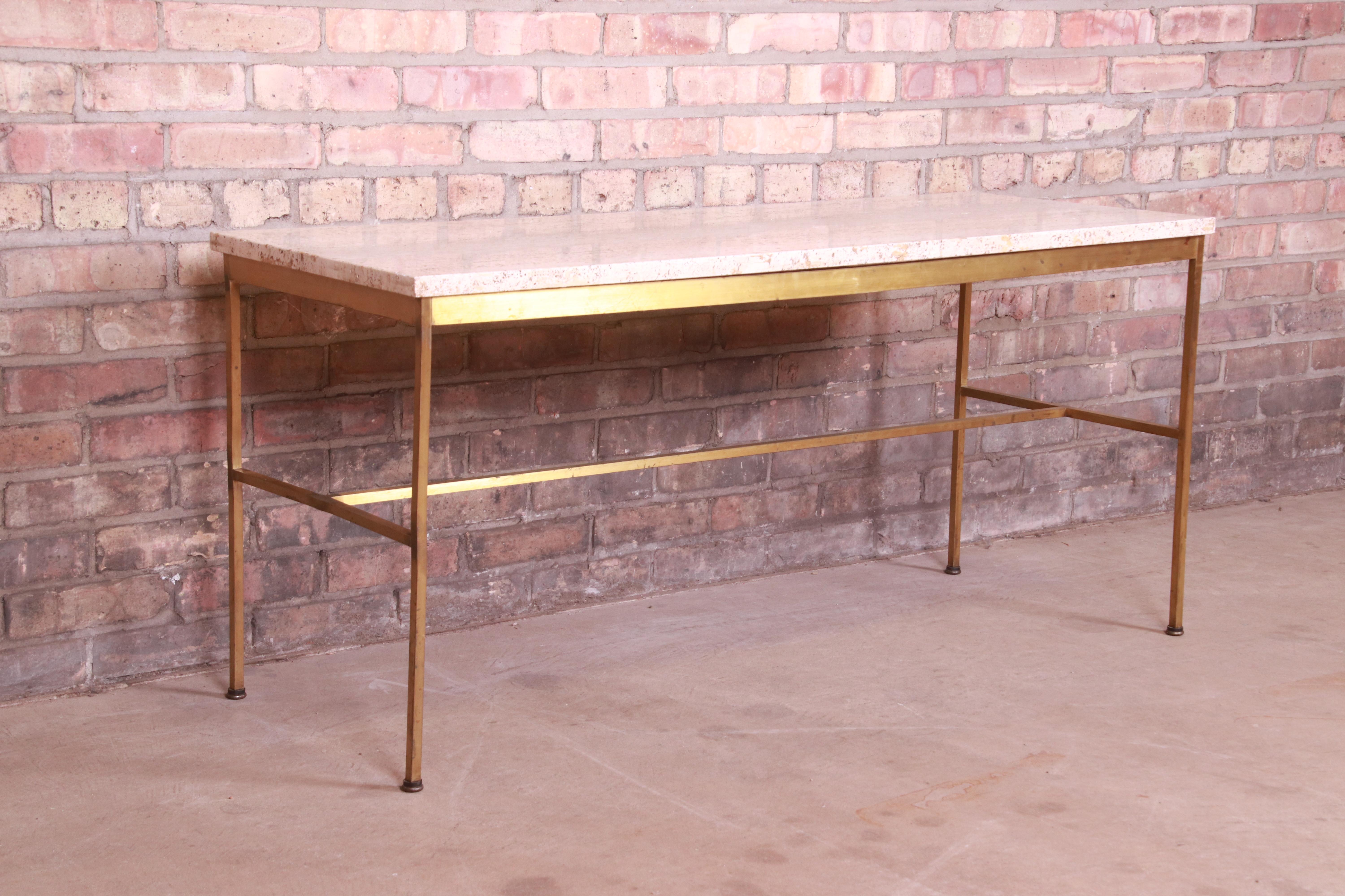 A gorgeous Mid-Century Modern coffee or cocktail table

By Paul McCobb for Directional and produced by Calvin Furniture

USA, 1950s

Brass base, with Italian travertine top.

Measures: 48