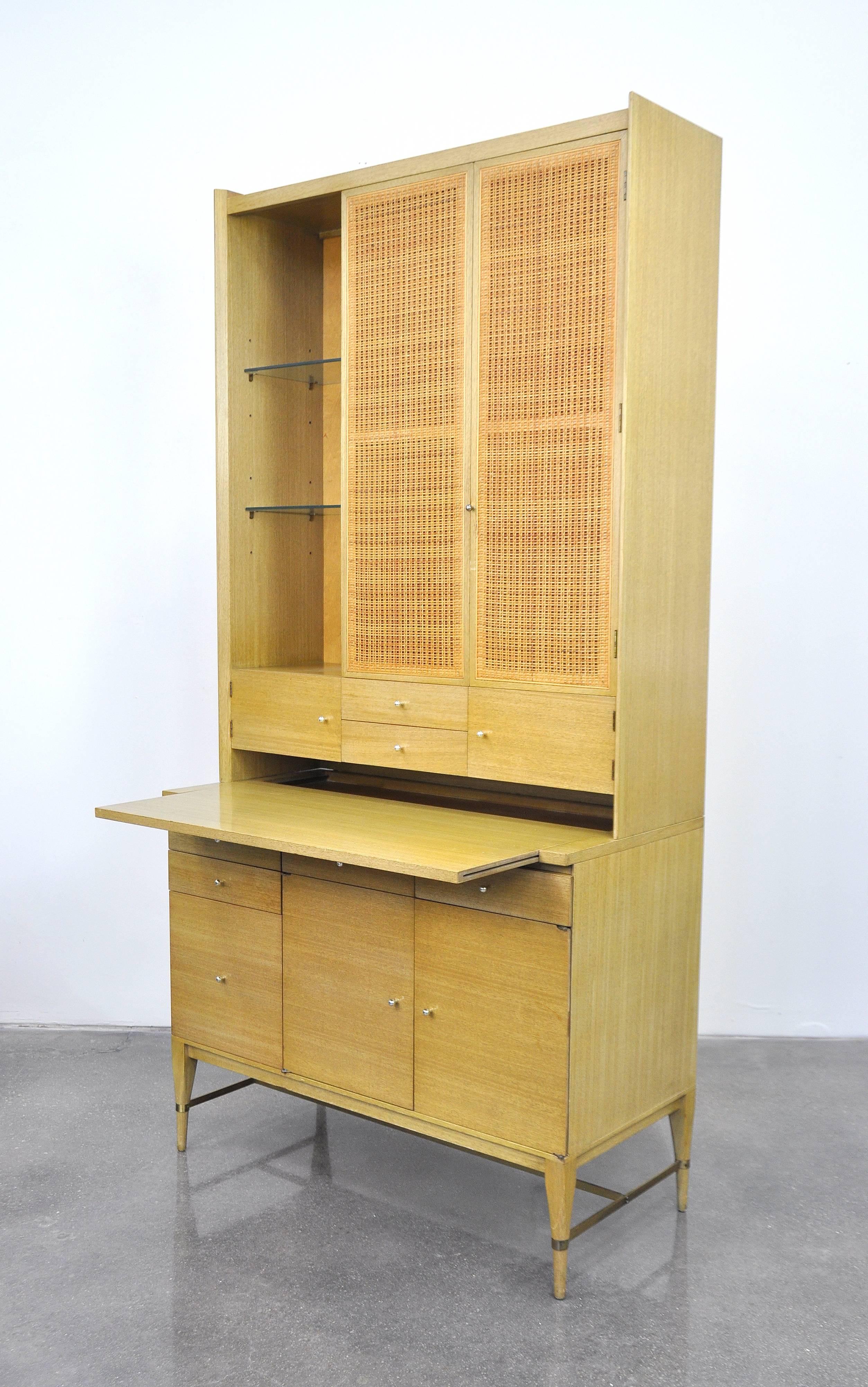 All original Mid-Century Modern bar cabinet, designed by Paul McCobb for Directional's Connoisseur Collection, and manufactured by H. Sacks and Sons in circa 1953. It can also be used as a cupboard, server buffet or as a desk and bookcase, as it