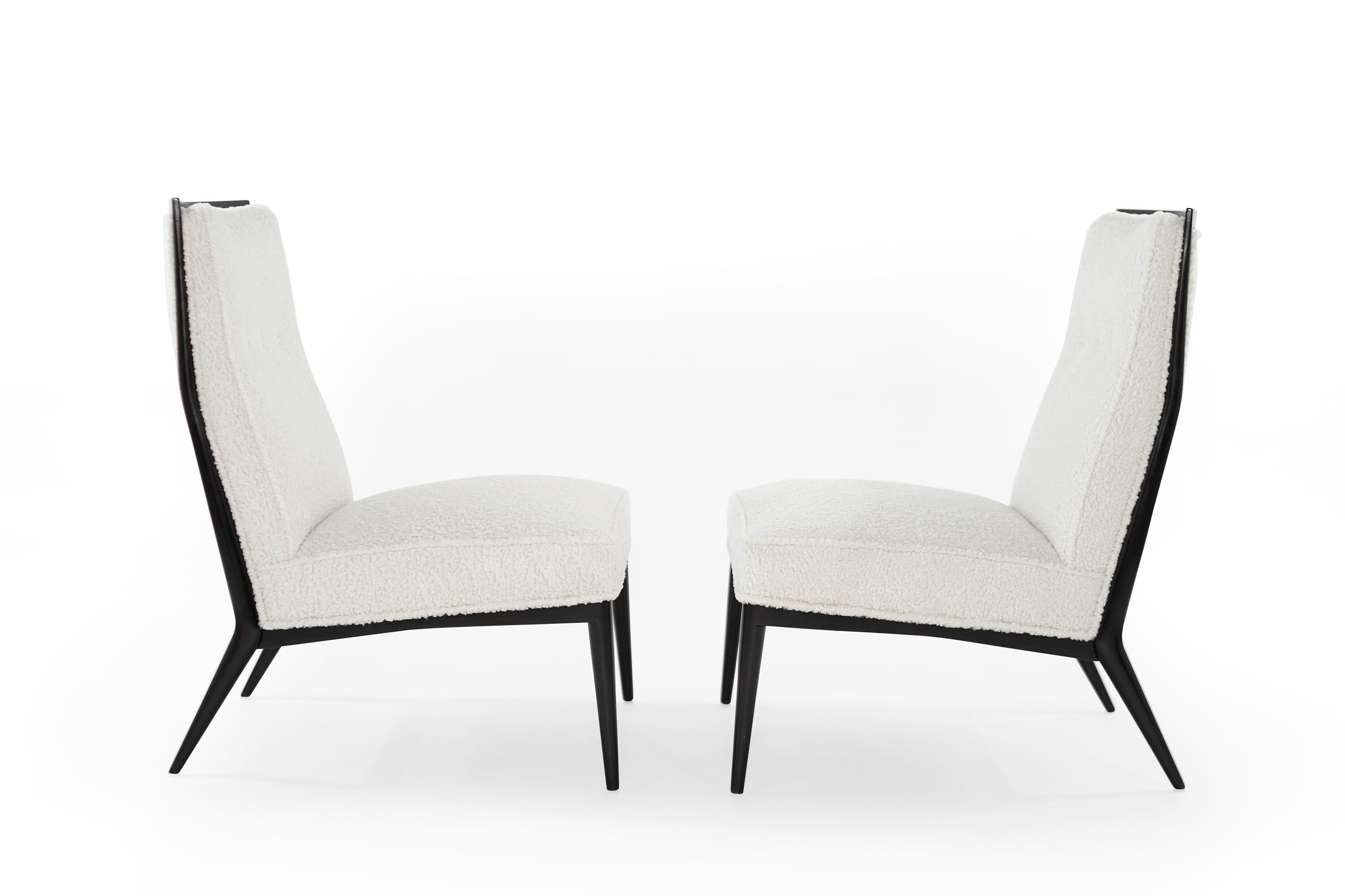 Uncommon set of beautifully restored slipper chairs designed by Paul McCobb for Directional, circa 1950s. Re-upholstered in off-white bouclé, maple frames refinished in espresso.