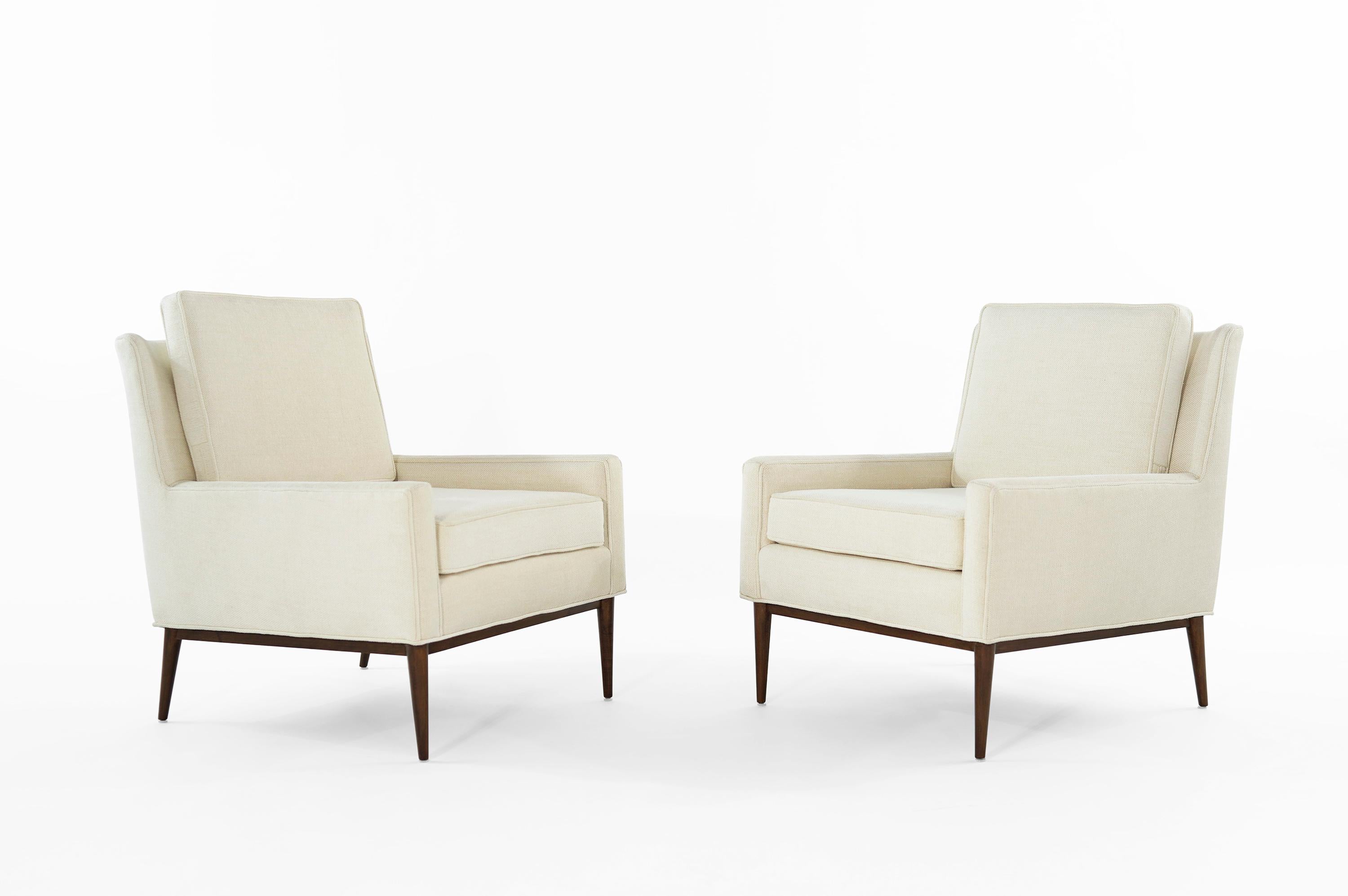 Set of iconic lounge chairs model # 302 designed by Paul McCobb for Directional, circa 1950s.

Newly upholstered in great plains off-white tweed by Holly Hunt, maple legs fully restored.
