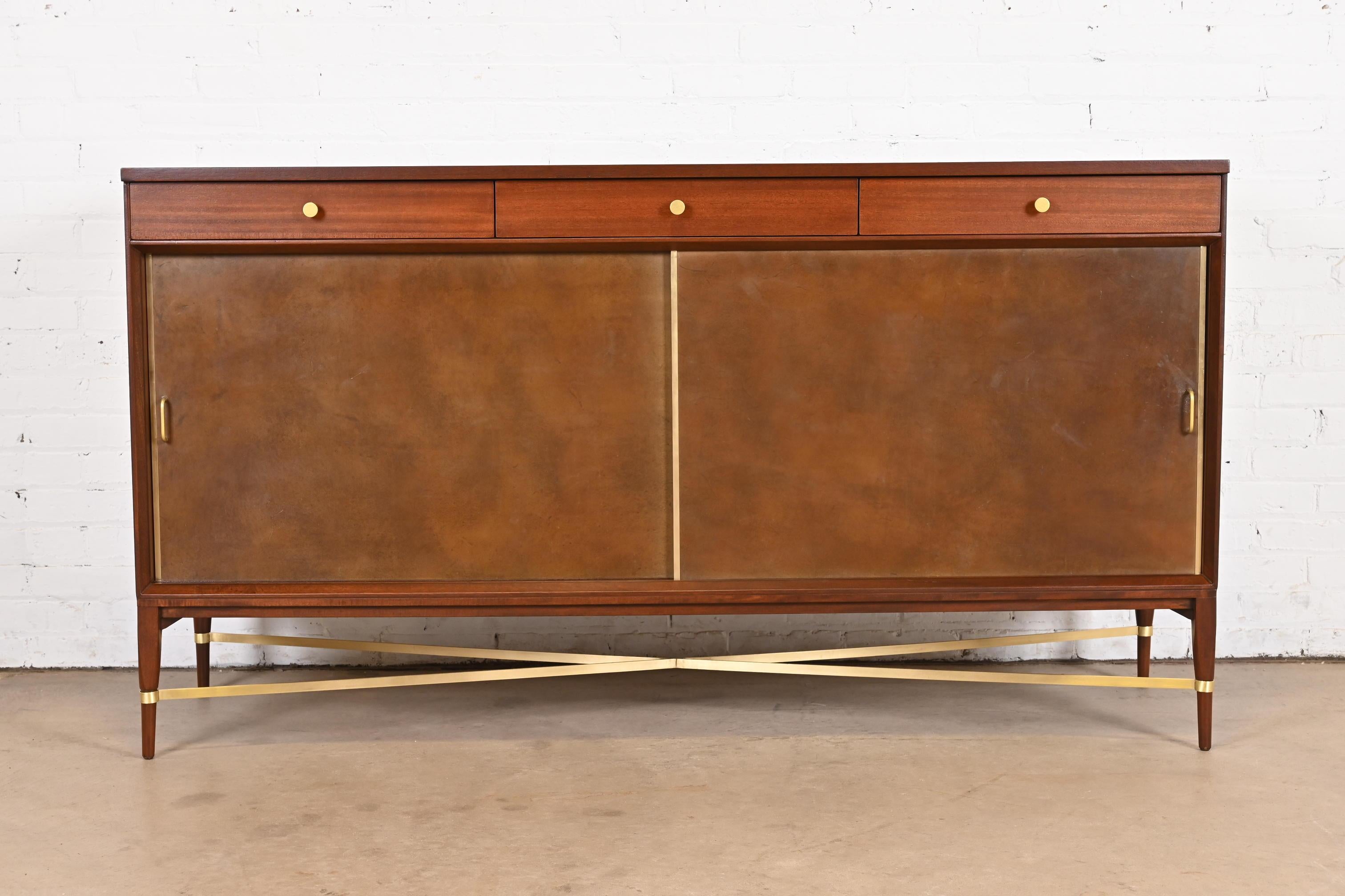 An exceptional Mid-Century Modern sliding door sideboard, credenza, or bar cabinet

By Paul McCobb for Directional and produced by Calvin Furniture

USA, 1950s

Mahogany, with brass stretchers and hardware, and sliding leather doors.

Measures: 66