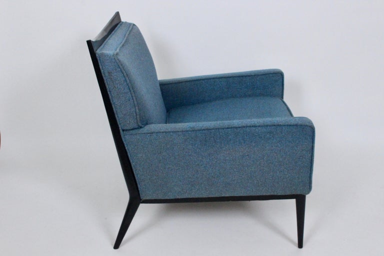 Paul McCobb for Directional Furniture 1322 lounge chair, loose seat cushion. Circa 1950s. Featuring a Black ebonized Walnut frame, tapered legs and comfortable curved back. Classic. American Mid-Century Modern.  As seen on page 87 of the