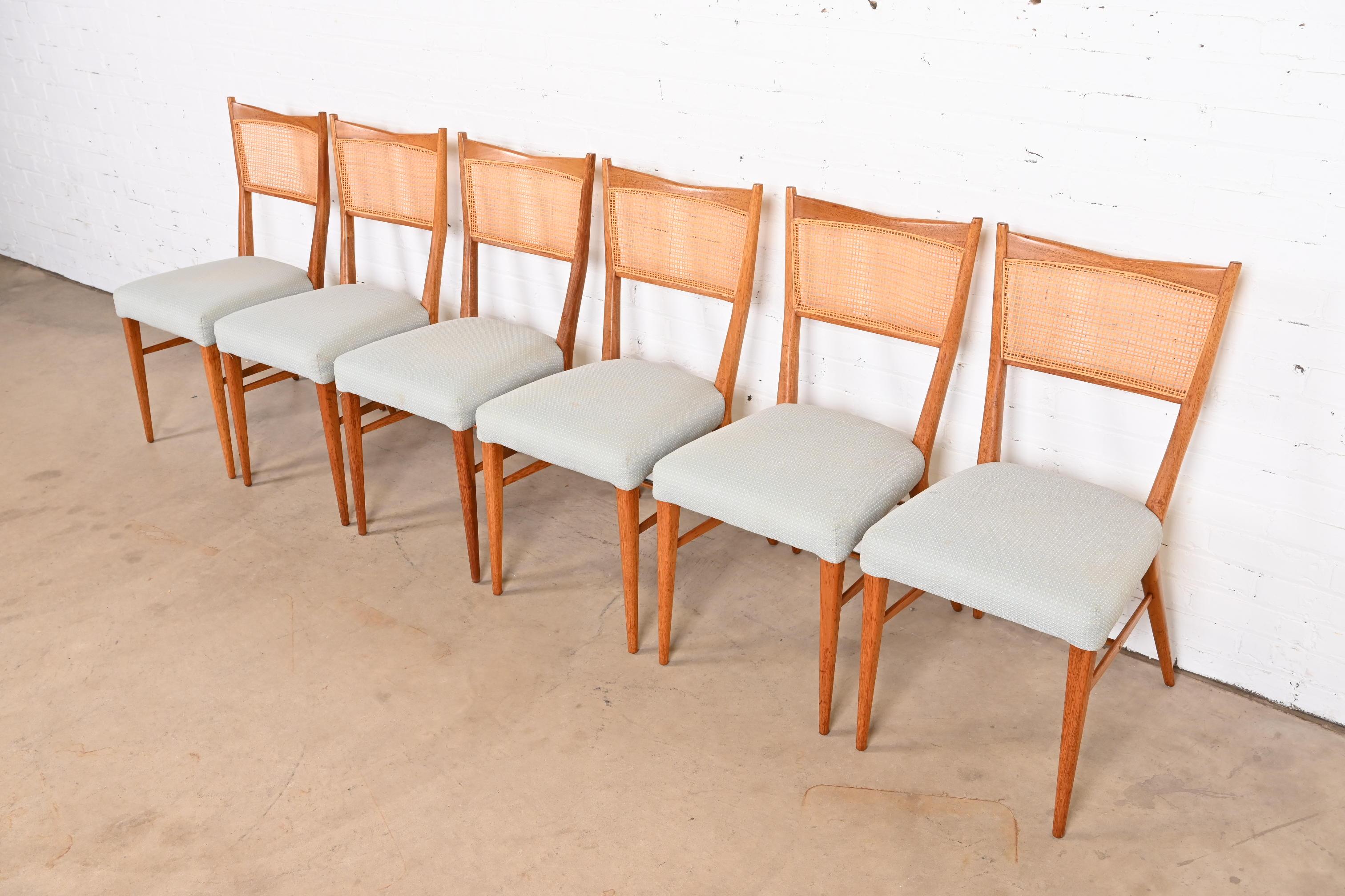A beautiful set of six Mid-Century Modern dining chairs

By Paul McCobb for Directional

USA, 1950s

Elegant sculpted mahogany frames, with cane backs, and upholstered seats.

Measures: 17