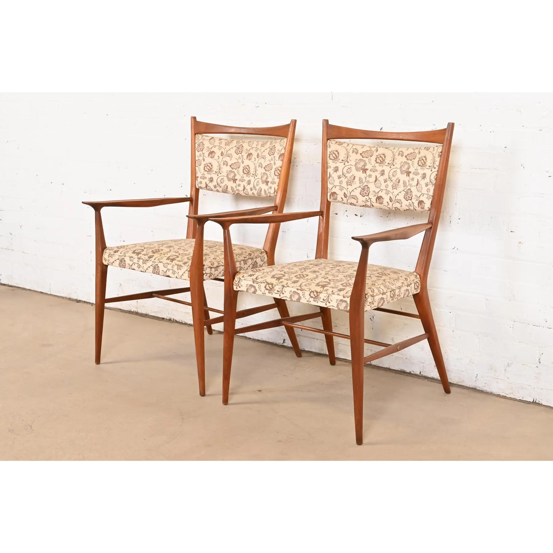  A gorgeous pair of Mid-Century Modern armchairs or dining captain chairs

By Paul McCobb for Directional

USA, 1950s

Elegant sculpted walnut frames, with upholstered seats and backs and brass accents.

Measures: 22.75