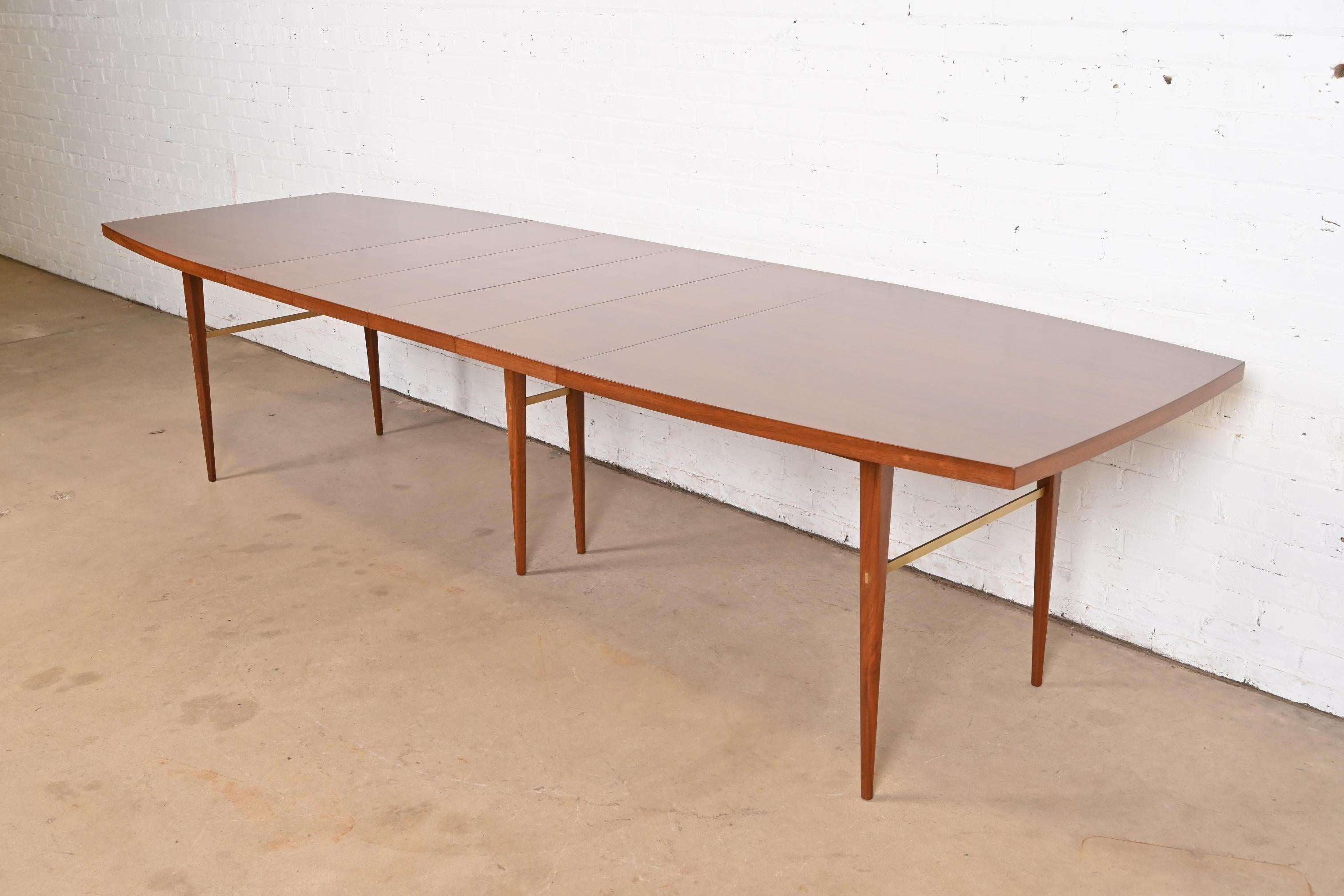 An exceptional Mid-Century Modern boat-shaped extension dining table

By Paul McCobb for Directional and produced by Calvin Furniture

USA, 1950s

Beautiful book-matched walnut, with brass stretchers.

Measures: 72