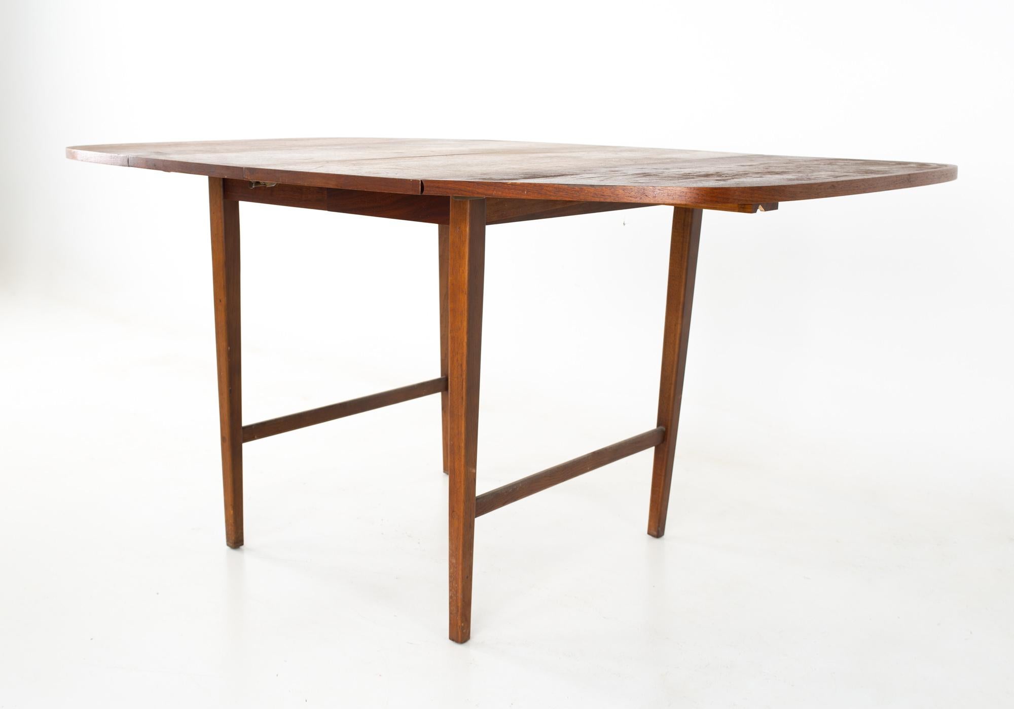 Paul McCobb for Lane Mid Century walnut drop leaf dining table
Table measures: 64.25 wide x 38 deep x 29 inches high 

All pieces of furniture can be had in what we call restored vintage condition. That means the piece is restored upon purchase so