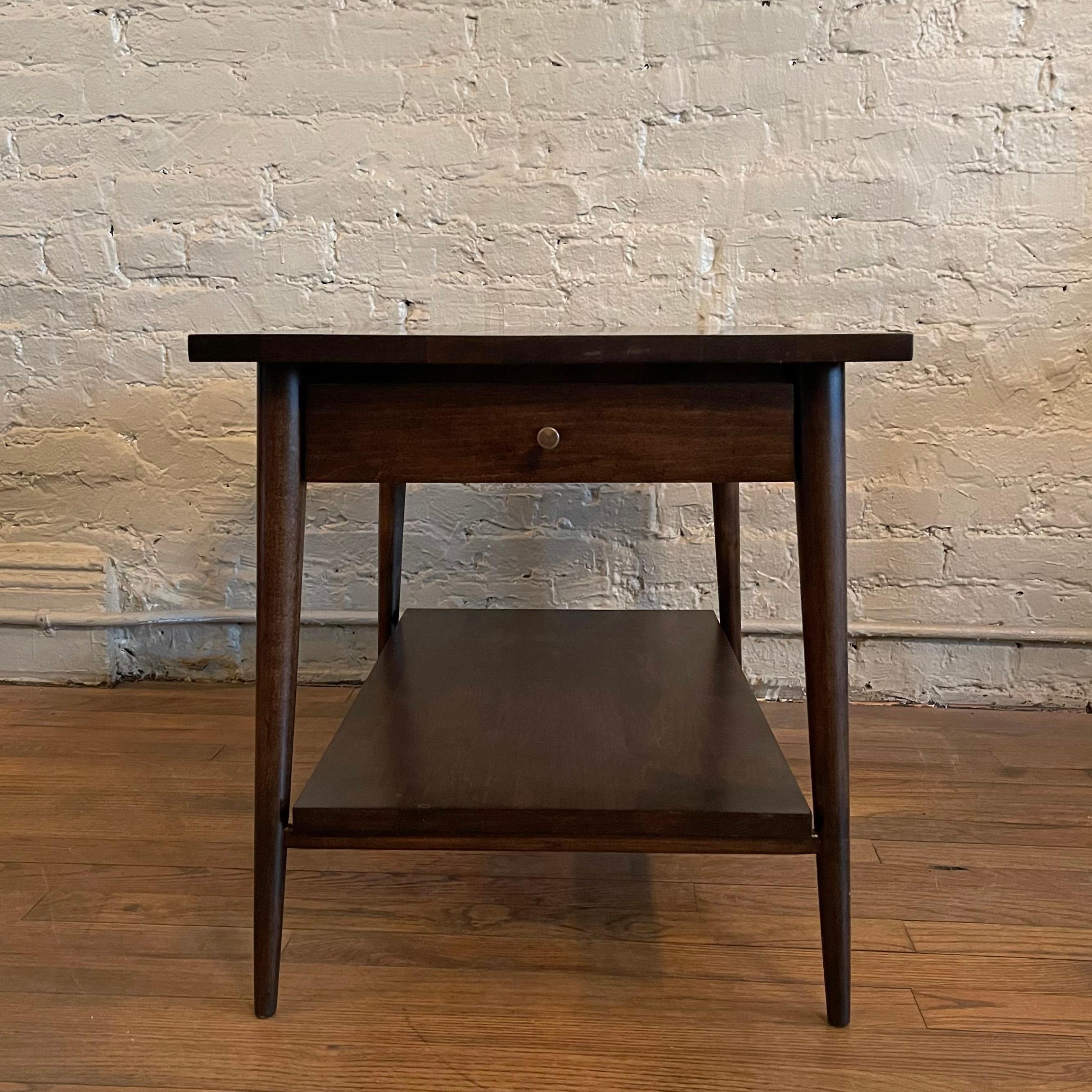 Mid-Century Modern, ebonized maple, side table with drawer by Paul McCobb for Planner Group, Winchendon, features a lower shelf and signature hourglass brass pull.