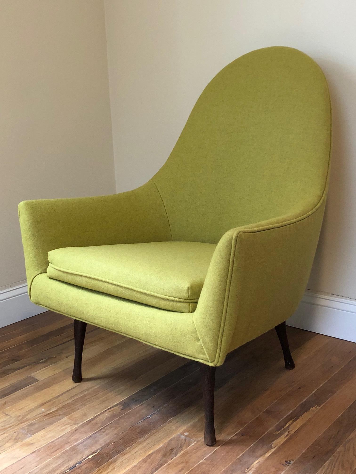 A Classic high back chair by Paul McCobb for Widdicomb. Shaped like a tall egg with unusual turned legs this chair has a great midcentury look and is very comfortable. Reupholstered in chartreuse wool.