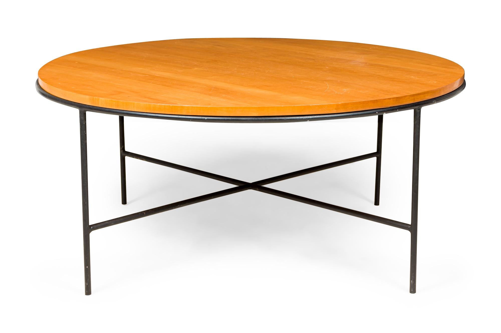 3 American mid-century circular coffee tables with blond maple tops supported on four legged iron stretcher frame bases. (PAUL MCCOBB FOR WINCHENDON FURNITURE COMPANY, PLANNER GROUP)(PRICED EACH)