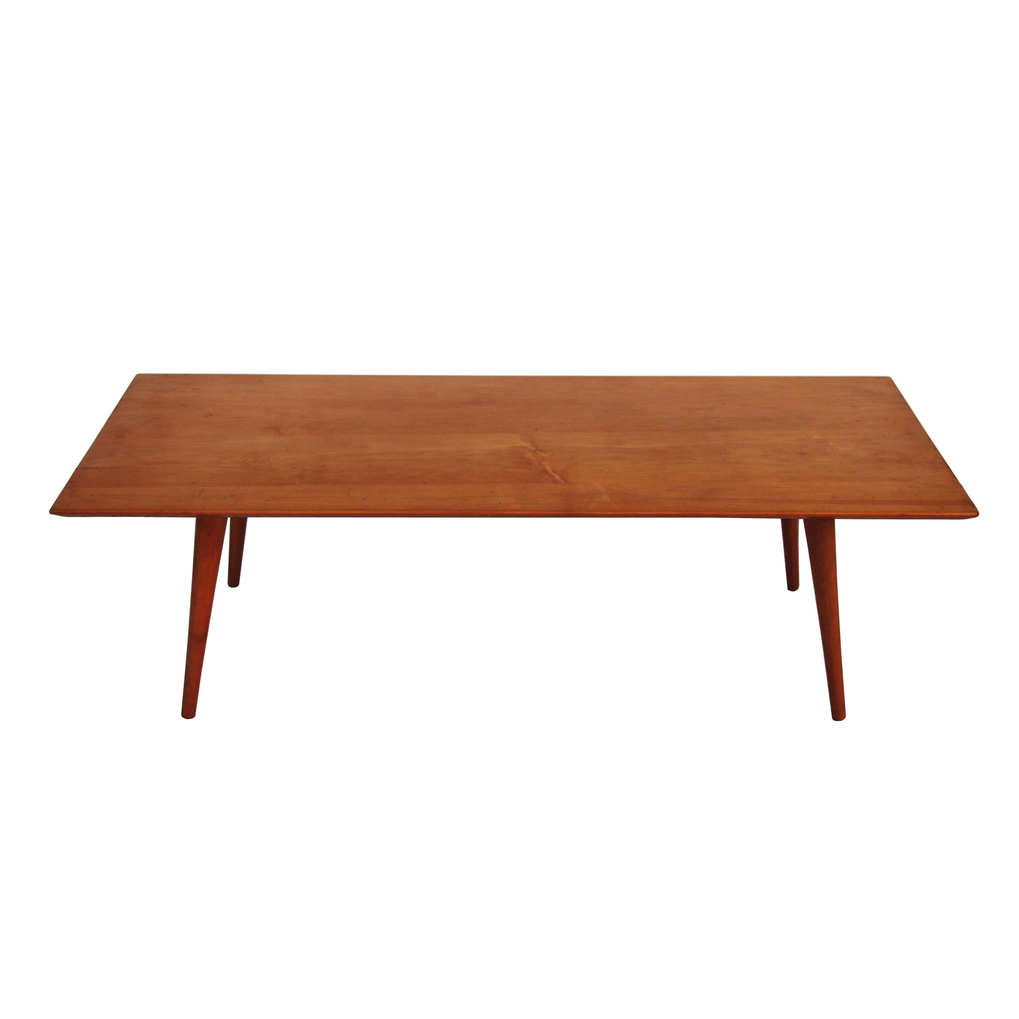 A Mid-Century Modern coffee table or bench designed by Paul McCobb and made by Winchendon.

 It features the simple lines, tapered legs and maple construction of Winchedon's Planner Group series.