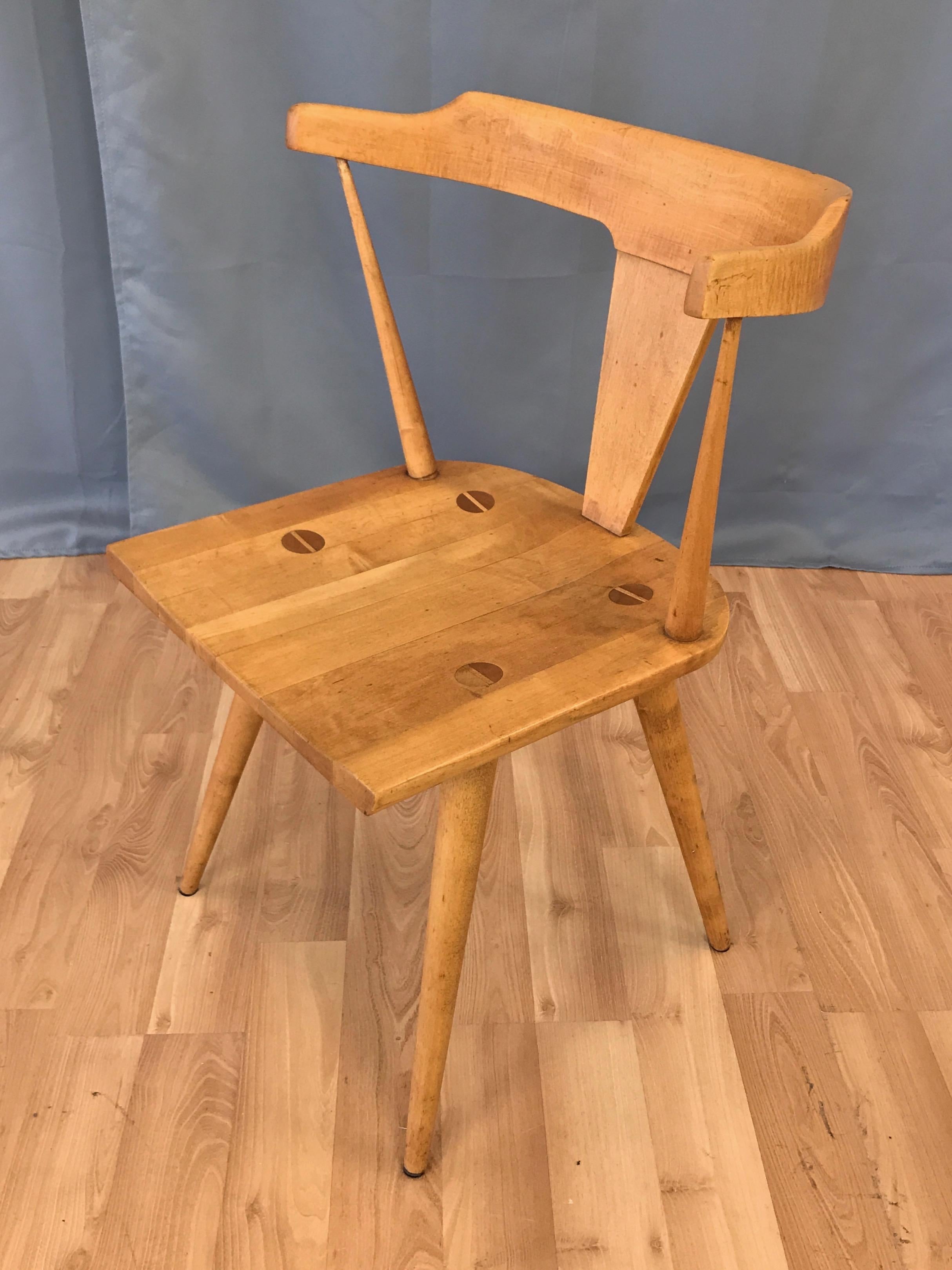 A less common model 1530 T-back maple armchair by Paul McCobb from his Planner Group collection for Winchendon Furniture.

Handsomely handcrafted of solid maple with signature exposed joinery on contoured seat. Splayed tapered legs mirrored by