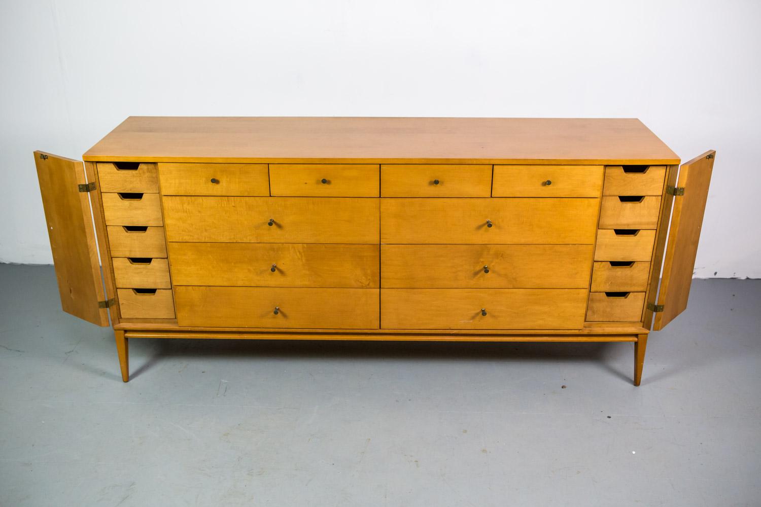 Planner Group for Winchendon Furniture. Designed and produced in the mid-1950s. Symmetrical drawer structure with four over six in center and another five drawers behind each door. All original hardware.