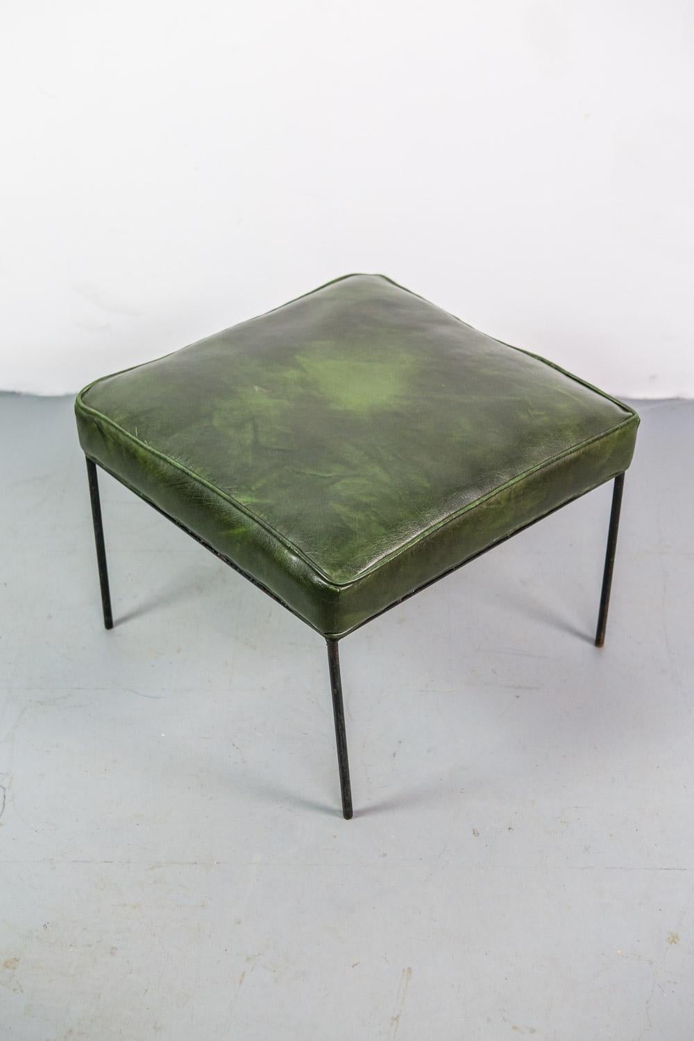 Original Paul McCobb Iron stool with vinyl seating surface in green skai upholstery.