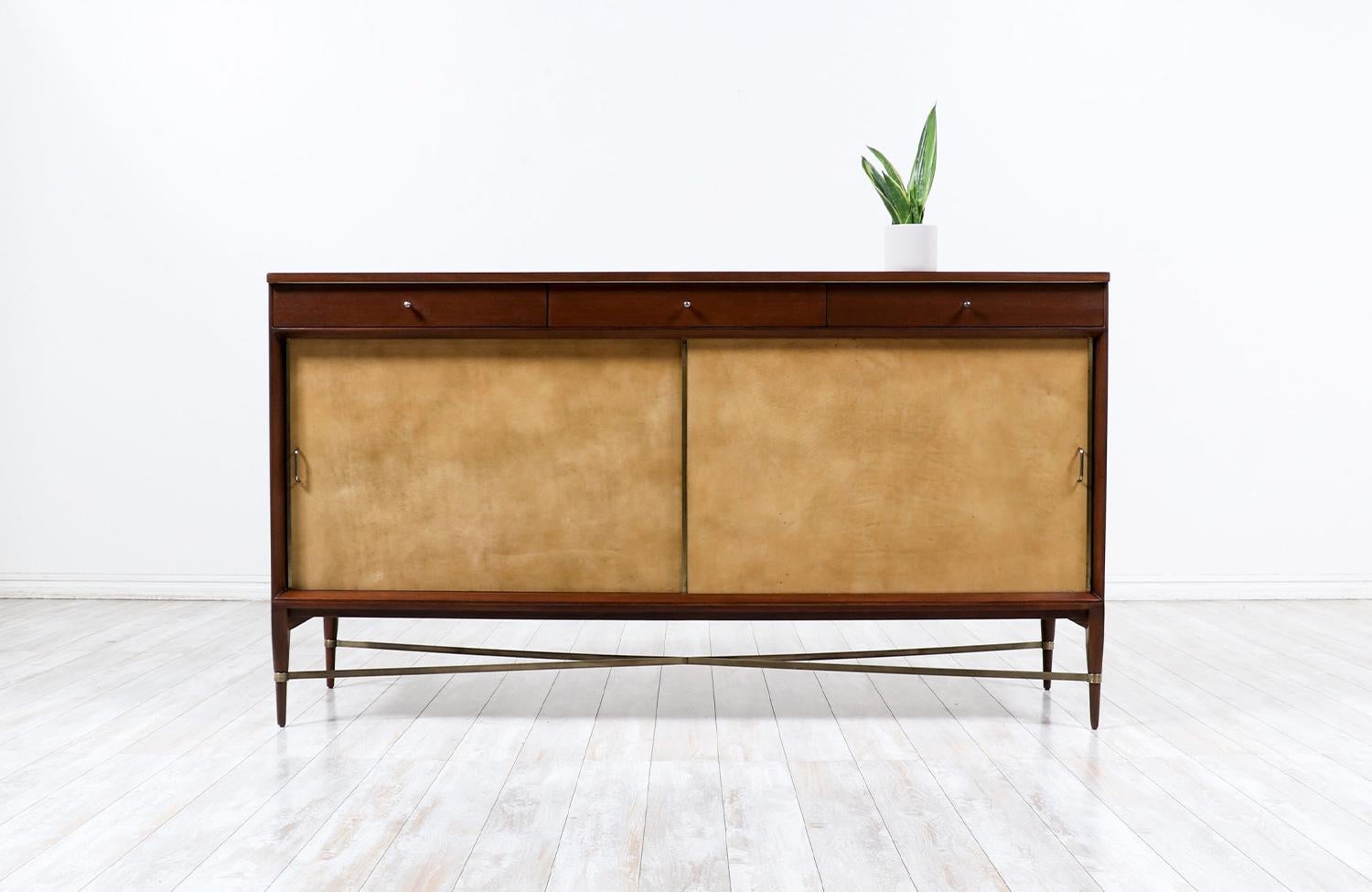 Introducing the exquisite Paul McCobb “Irwin Collection” Credenza with Leather Doors & Brass Accents for Calvin Furniture. With its exceptional design and the use of high-quality materials, this credenza exudes elegance and sophistication.
This