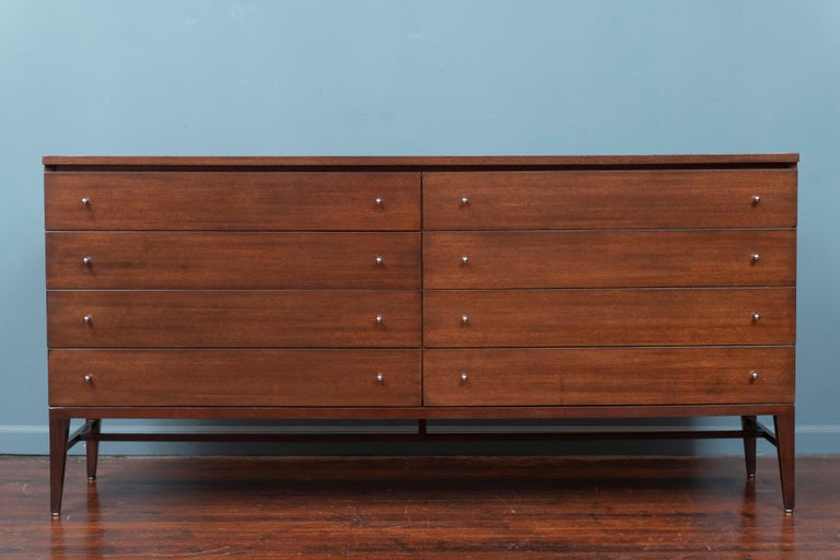Paul McCobb design mahogany eight drawer dresser for his Irwin Collection produced by Calvin Furniture. High quality materials and construction with easy action drawers. Newly refinished in its original expresso finish with polished rain drop pulls,