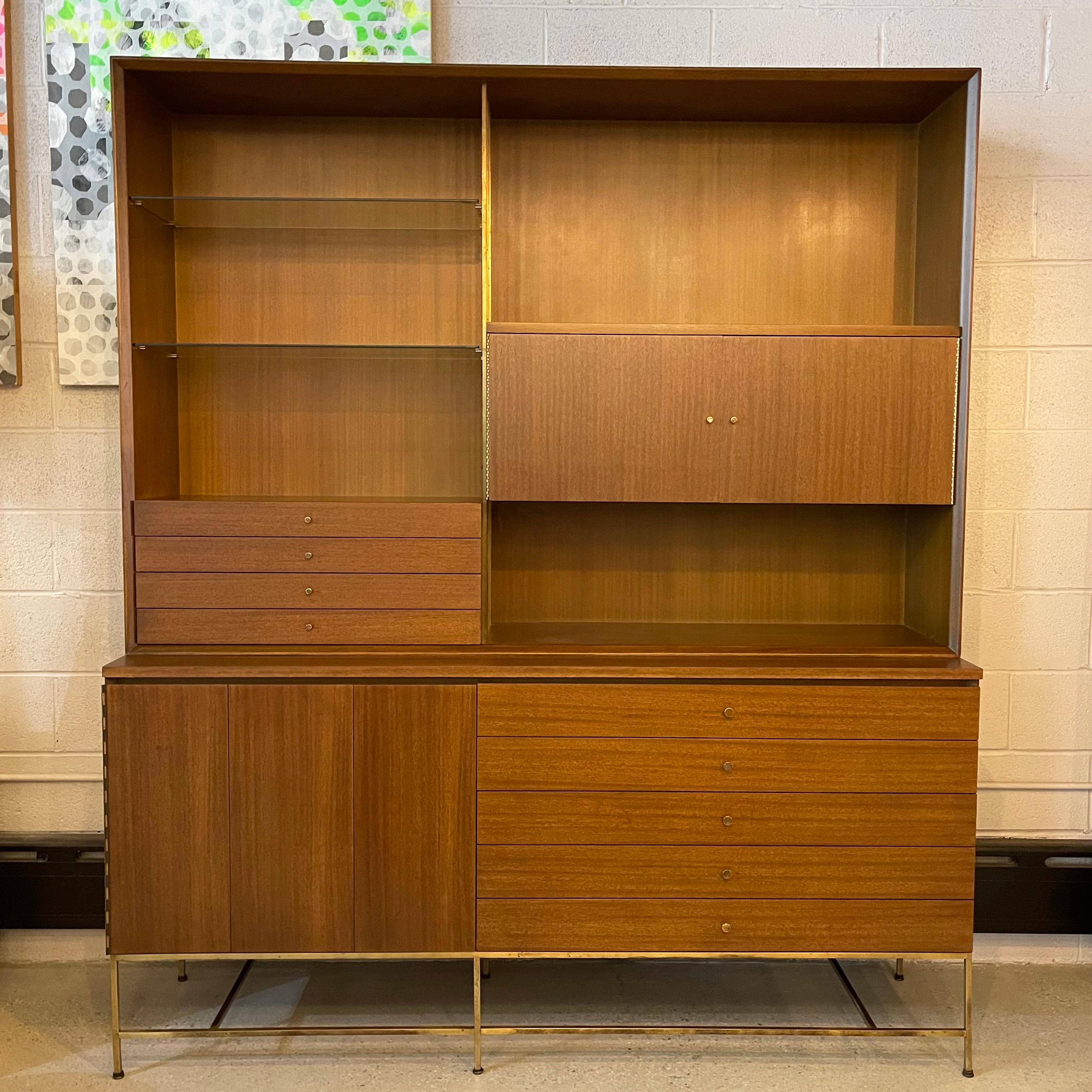 Mid-Century Modern, two piece, walnut and brass, wall unit hutch credenza by Paul McCobb for Calvin Furniture, Irwin Collection features a bottom credenza with recessed wall unit hutch on top. There are brass accents throughout; base, rails and