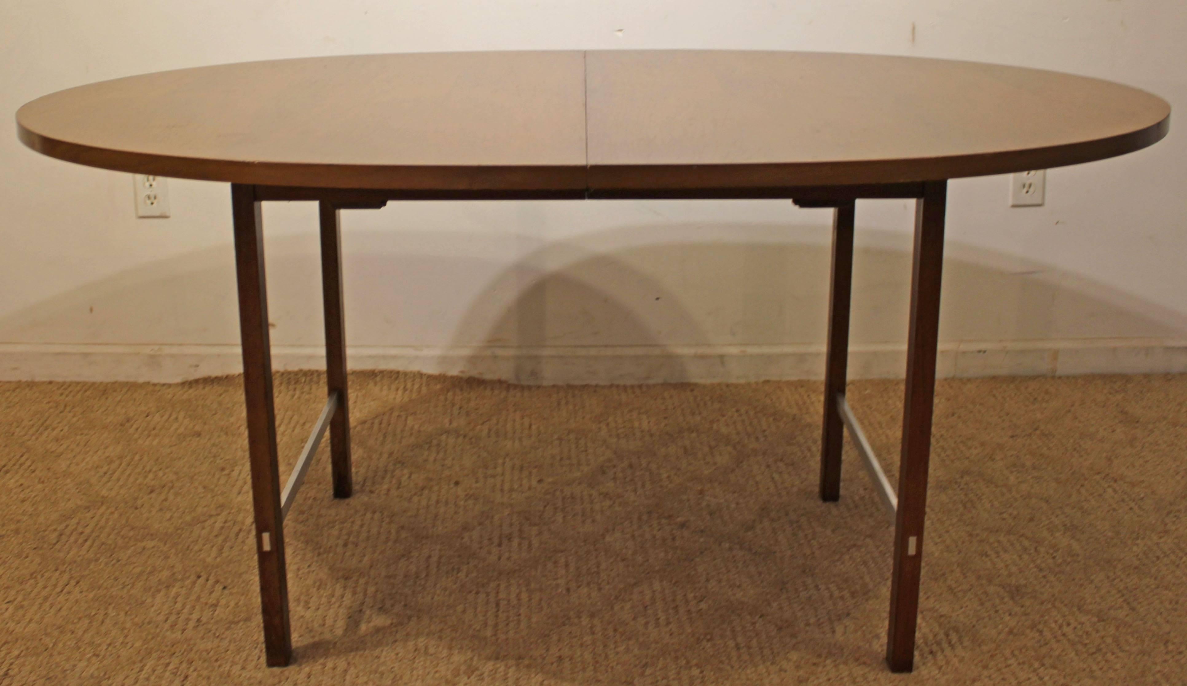 Designed by Paul McCobb for the Irwin collection by Calvin. The table is made of walnut with aluminium braces. Does not include table leaves.