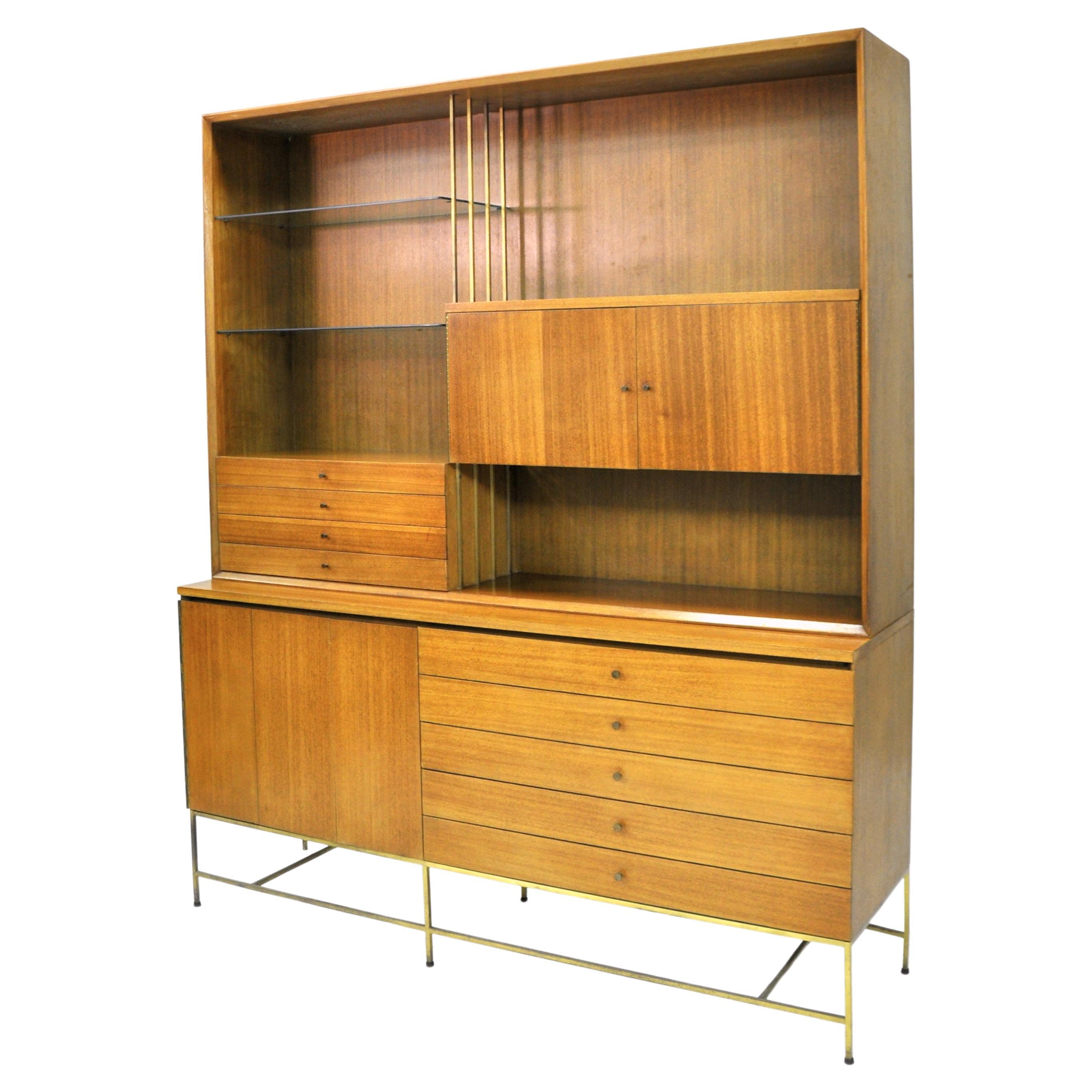 All original Paul McCobb mahogany and brass cabinet model C8506 with breakfront top model C8006, from the Irwin Collection by Calvin Furniture, which is part of the work the designer created for Directional. The two piece mid-century modern credenza