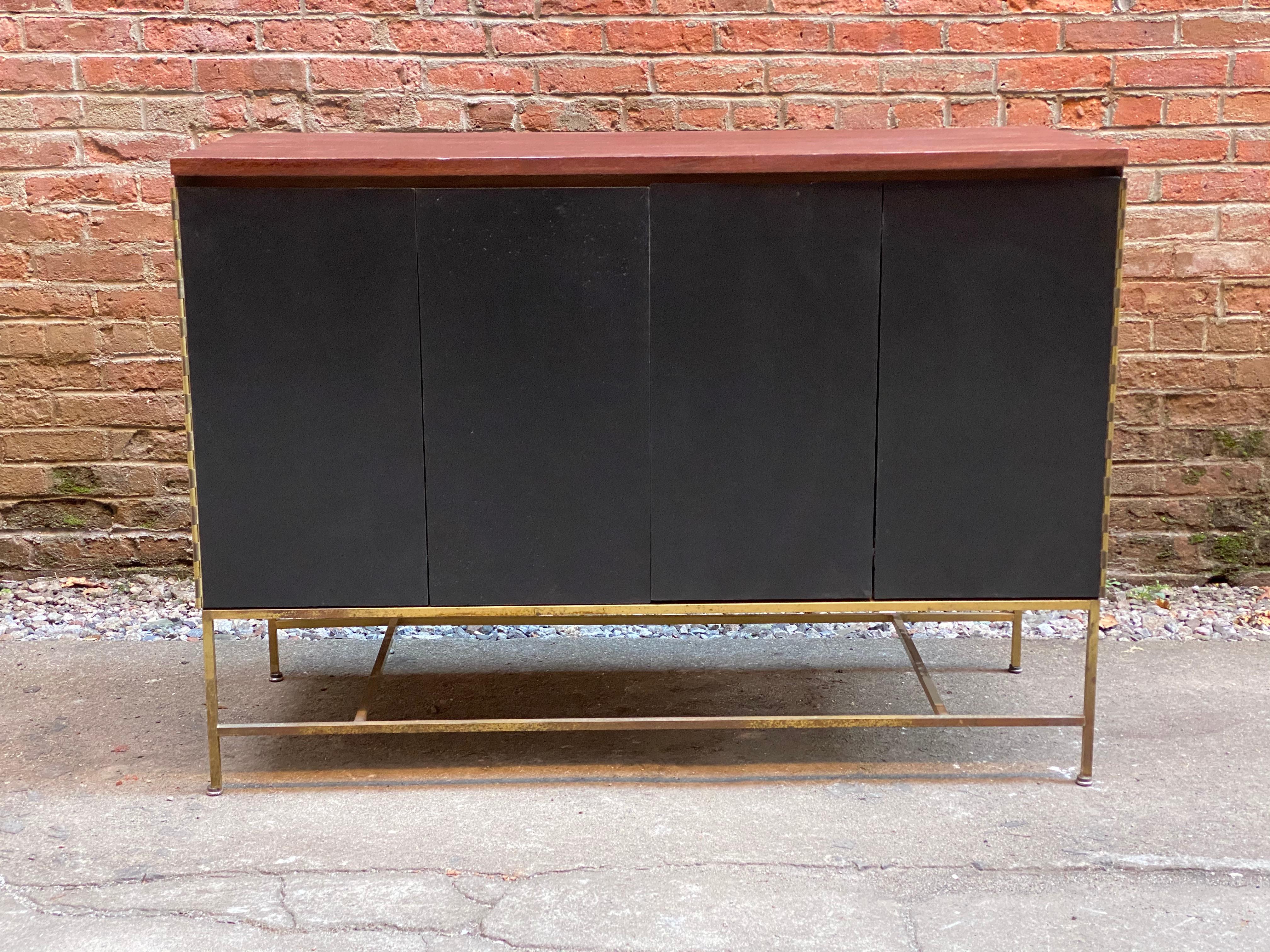 Mahogany case with ebonized doors. Four interior drawers with adjustable shelf. Signed in top drawer. Good refinished condition with wear commensurate with age and use. Some minor cracks to the feet on metal base (see photo).

Approximately 19.25