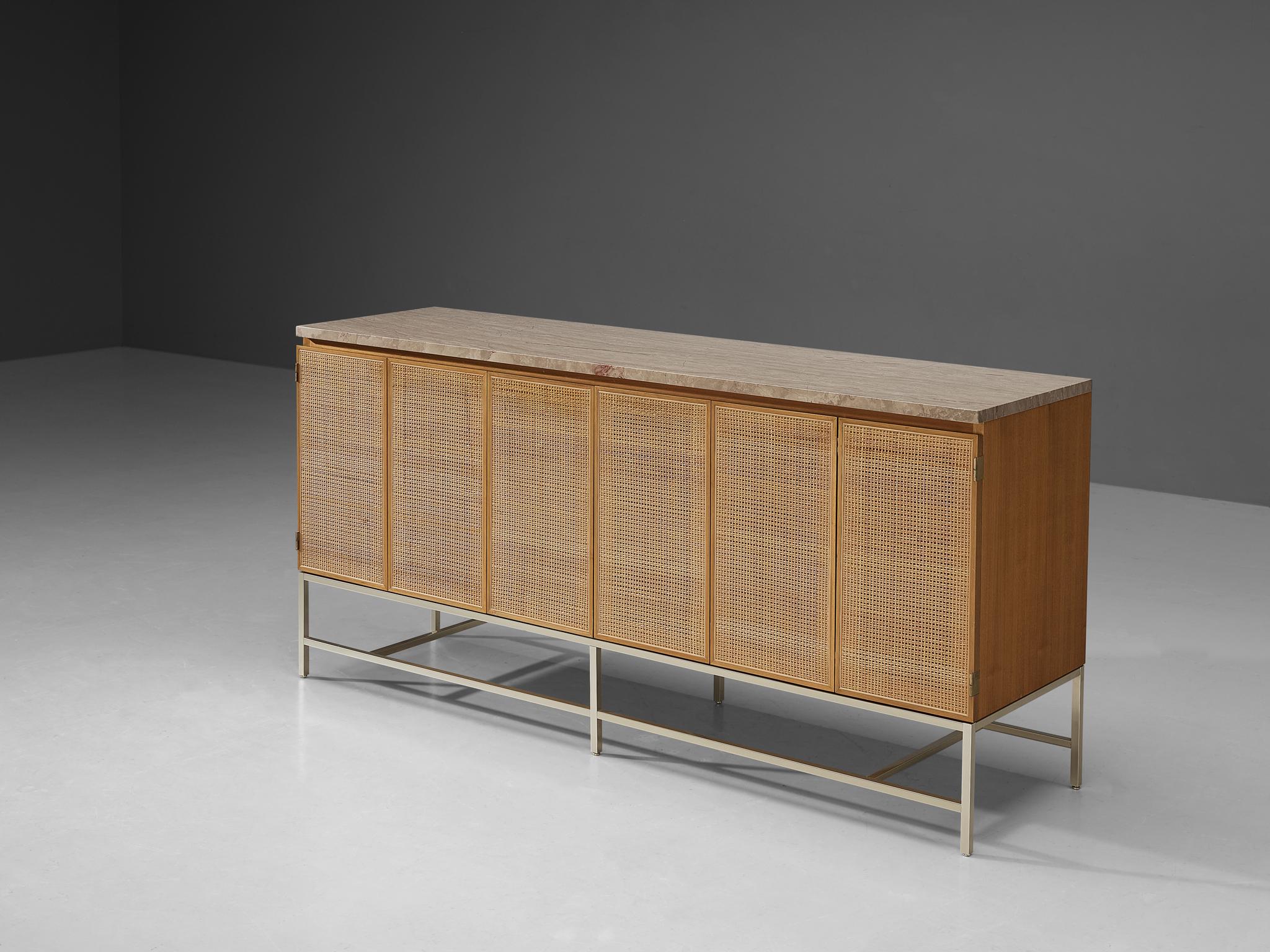 Paul McCobb for Calvin, sideboard, part of the 'Irwin' series, walnut, cane, marble, brass, United States, circa 1950s. 

This alluring credenza is designed by Paul McCobb. The quintessential design features of McCobb's furniture is clearly