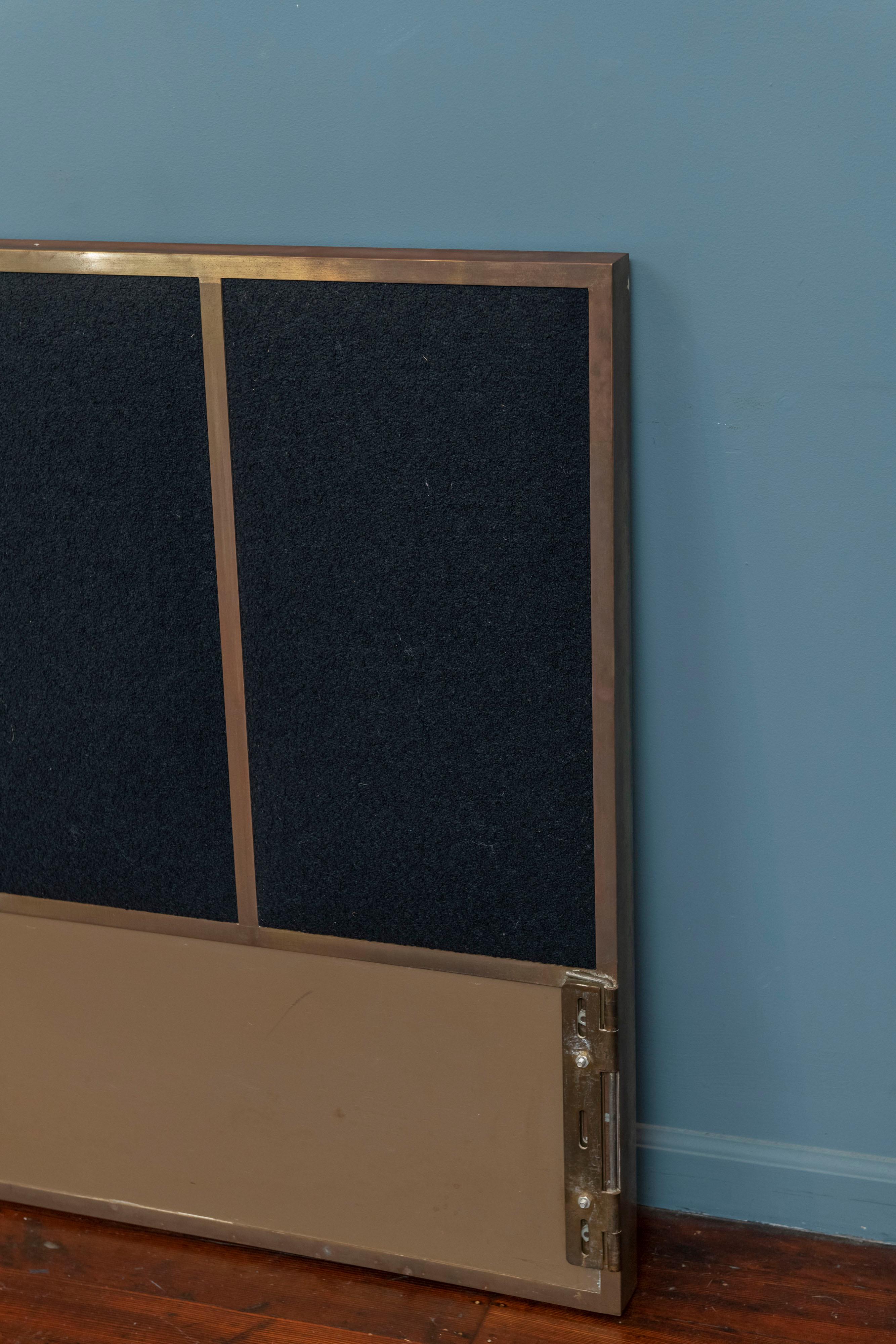 Paul McCobb design king size headboard for Calvin. Classic Mid-Century modern lines with a brass plated frame and newly upholstered black boucle upholstery. Solid and heavy, made to last and easy to attach to any metal bed frame. Headboard only.