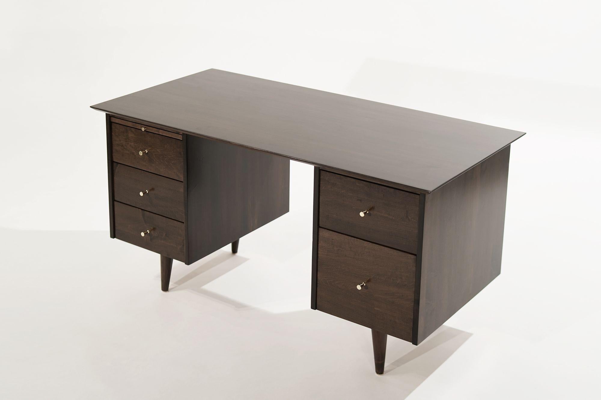 Kneehole desk designed by Paul McCobb, circa 1950-1959. Executed in maple, completely restored, and stained with our medium walnut. Brass hardware hand polished.
 
Other designers from this era include Paul McCobb, George Nakashima, Tommi