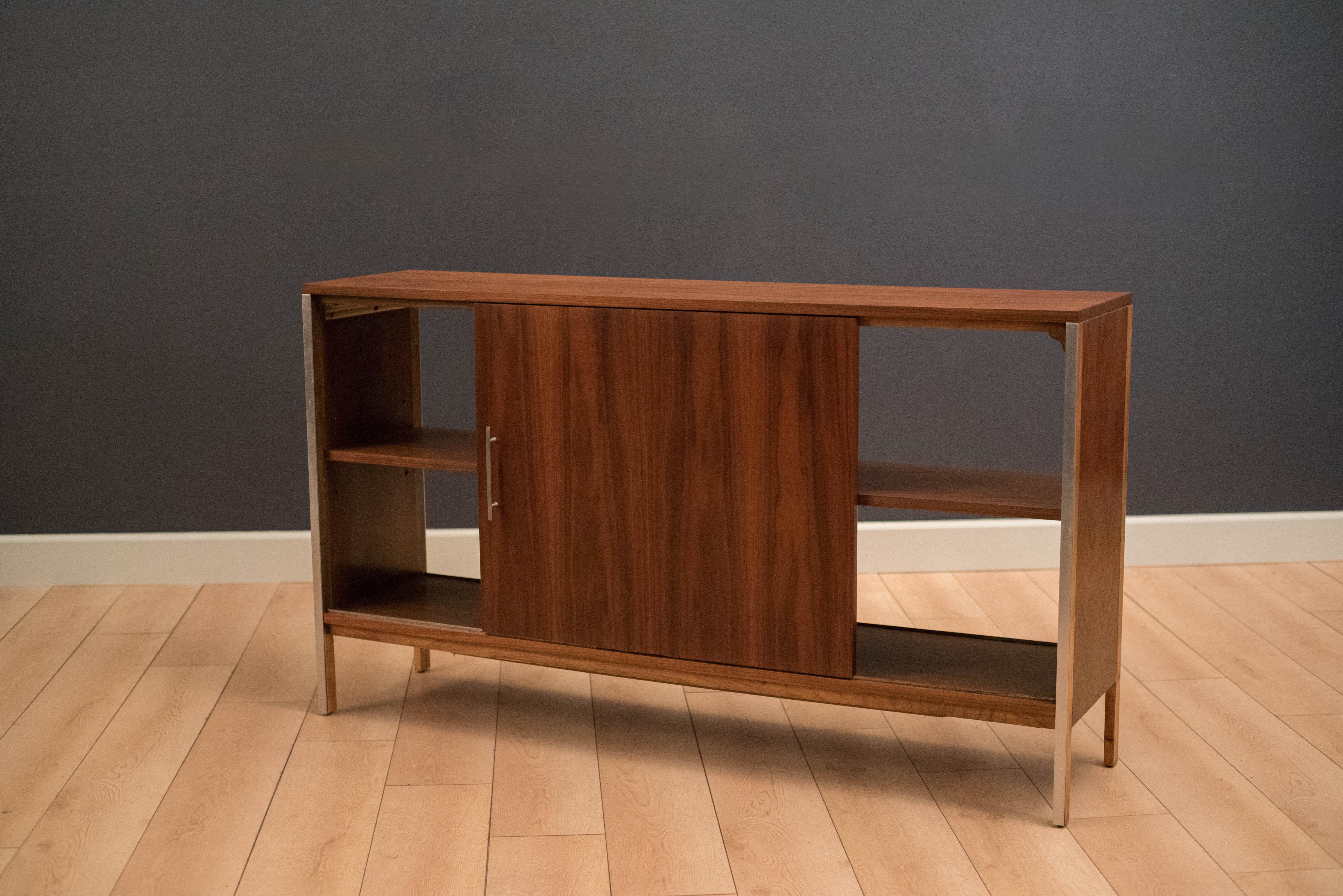 Mid-Century Modern room divider cabinet designed by Paul McCobb for the Linear collection of Calvin furniture. This versatile piece can function as a media console and displays from any angle as a room divider. Both sides of the cabinet are finished