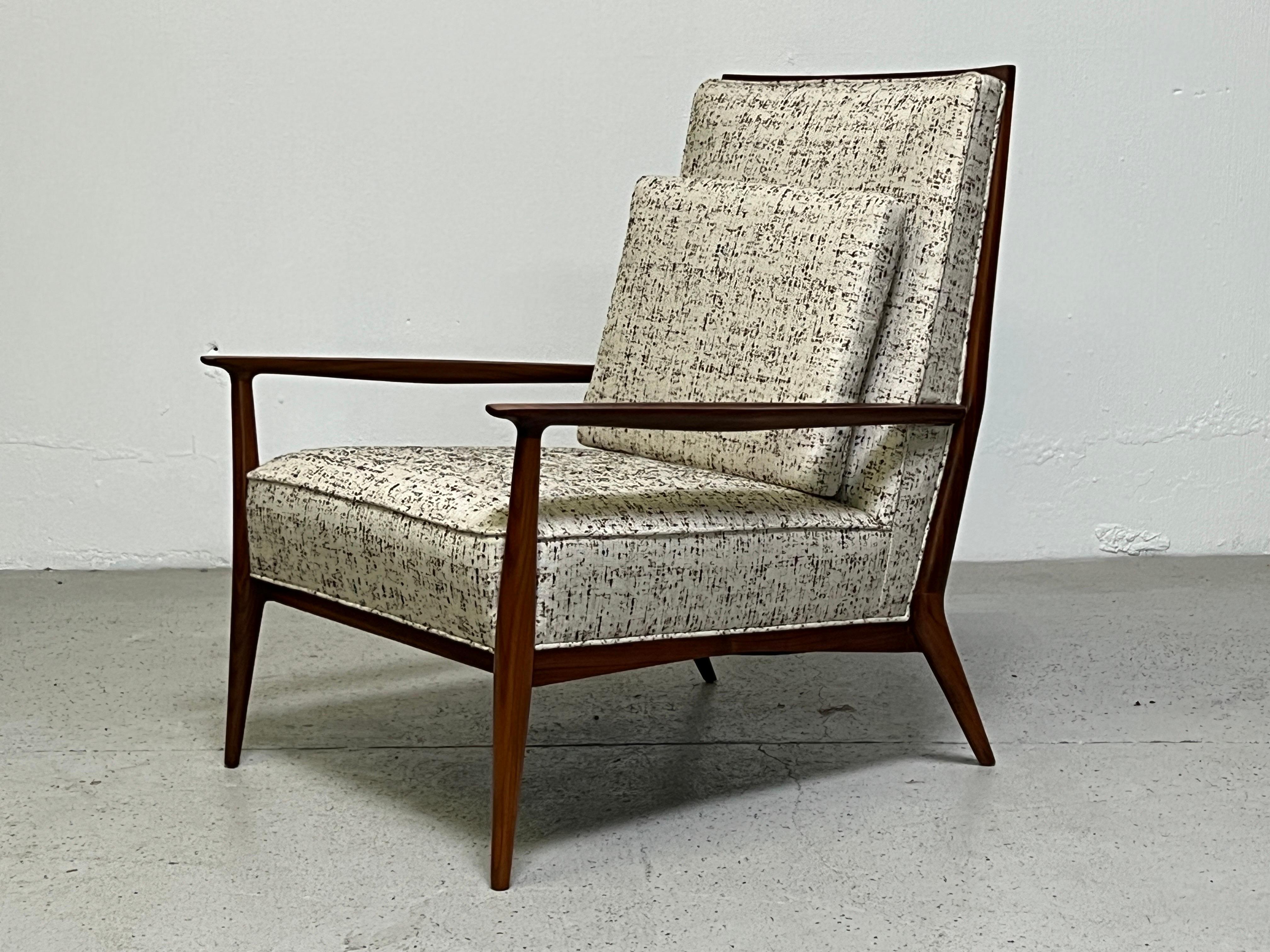 A sculptural high-back lounge chair with walnut frame designed by Paul McCobb. Refinished and reupholstered.