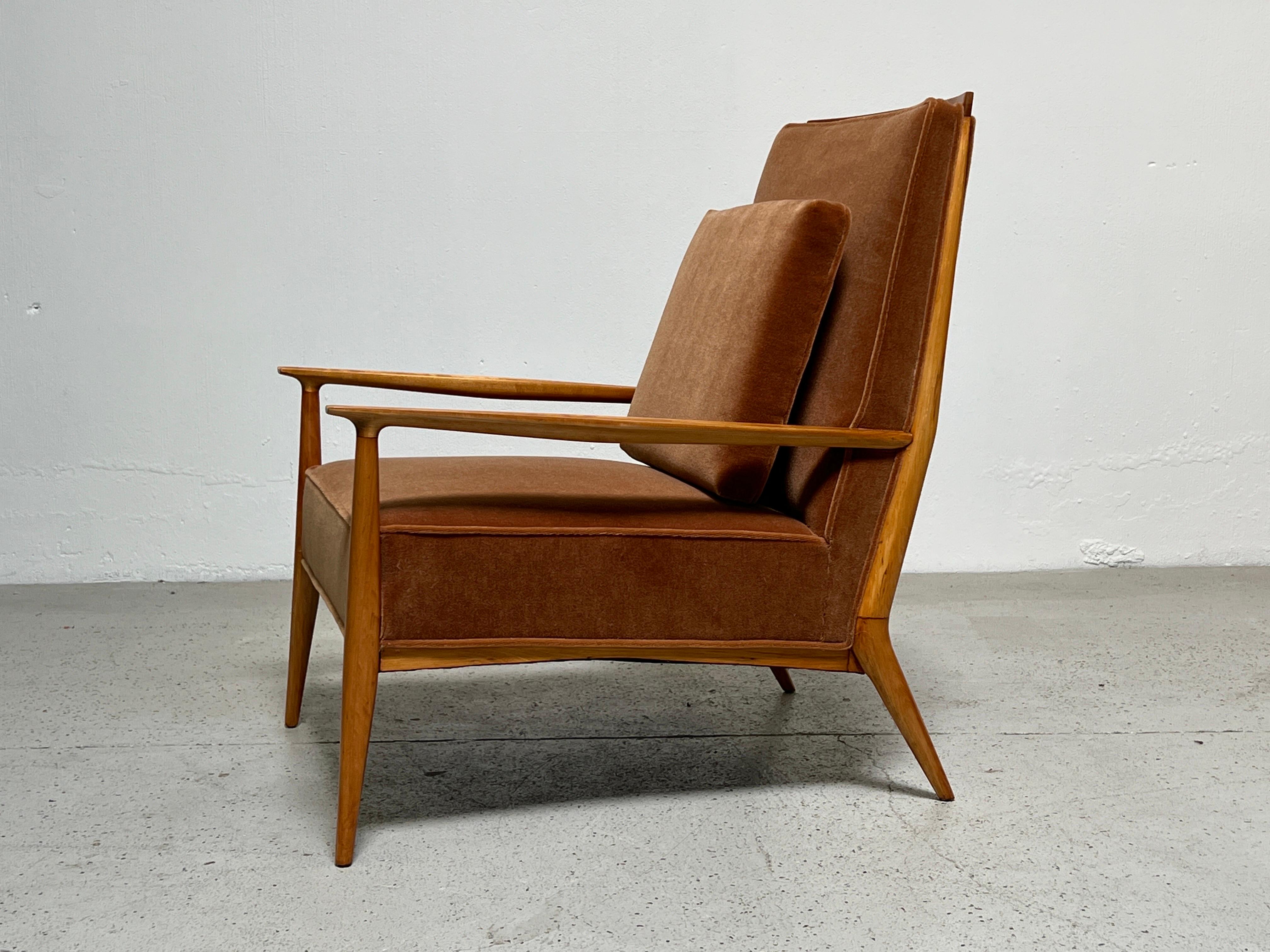 A sculptural high-back lounge chair with maple frame designed by Paul McCobb. Refinished and reupholstered in mohair.